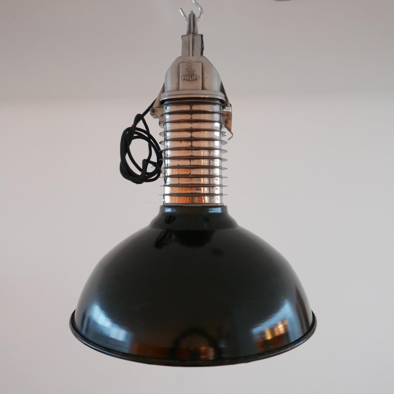 A pair of immaculate industrial pendant lights of superior quality.

Holland, c1950s.

Cast aluminium tops have been polished, the enamel large shade is in amazing condition with a white interior.

Re-wired and PAT tested.

PRICE IS FOR THE