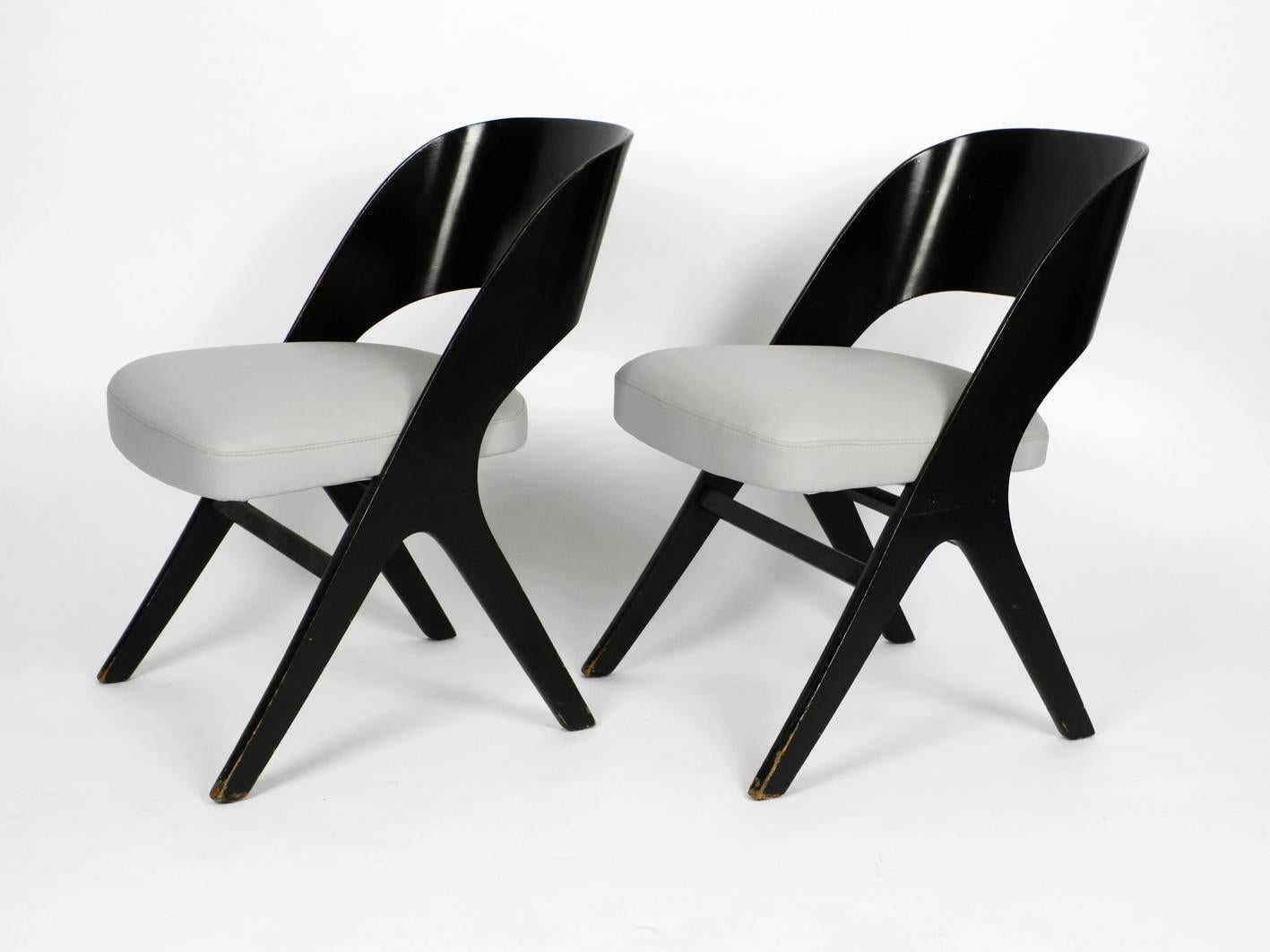 Pair of very rare and beautiful original Mid-Century Modern black and grey chairs by Carl Sasse for Casala reupholstered.
X legs made of black lacquered wood. Curved backrest made of plywood.
Very high quality and great minimalistic 1950s design