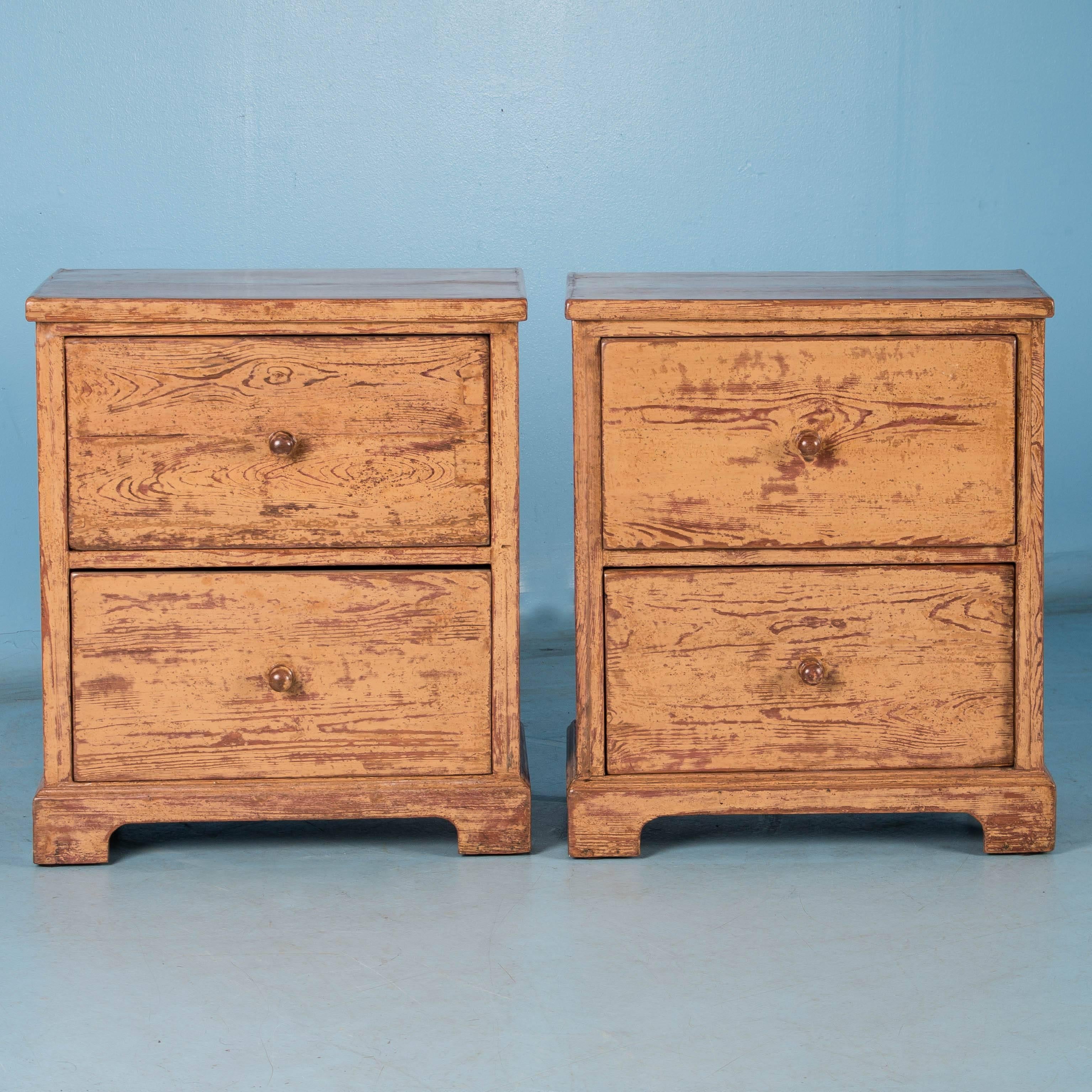 This pair of matching two-drawer cabinets or chest of drawers is unique. One first notices is the beautiful paint, with the original layer of brick red underneath which was later painted over with yellow. Now the layers of paint create great
