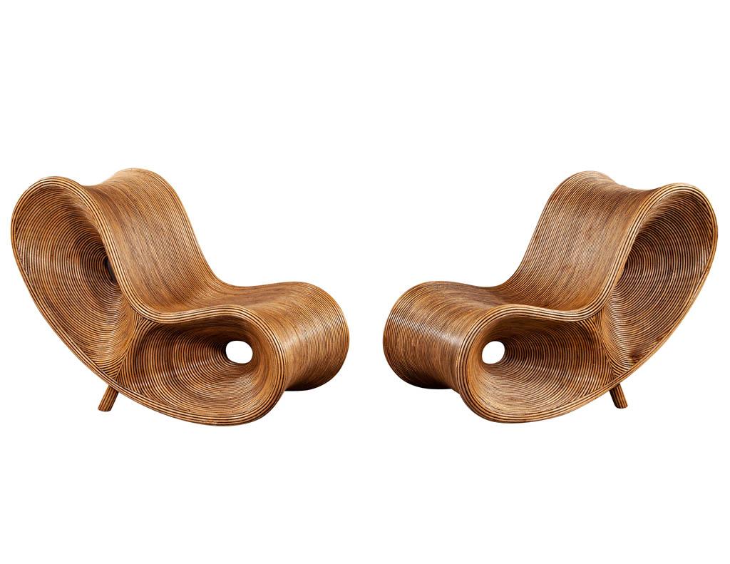 Pair of original pencil reed rattan sculptural ear chairs. All original in excellent condition. Featuring unique curved shapes with infinity rattan design. A truly unique and bold piece for any room.

Price includes complimentary curb side