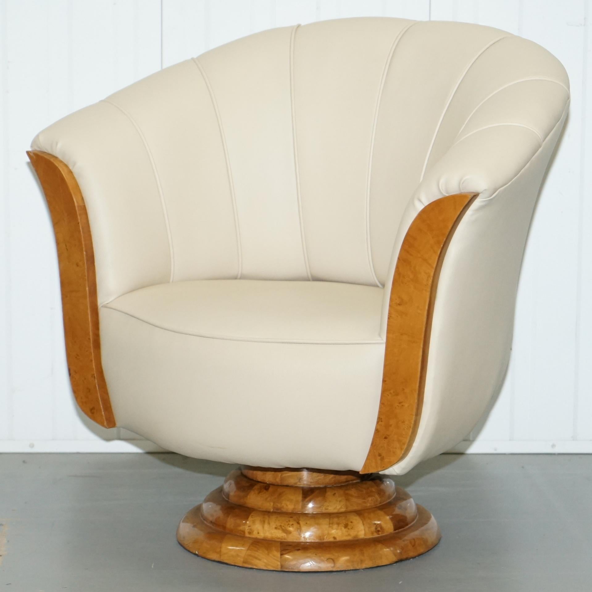 We are delighted to offer for sale this lovely pair of original Art Décor Tulip armchairs with cream leather upholstery and burr maple veneer

A very decorative and highly sort after pair in excellent vintage condition throughout, the burr walnut