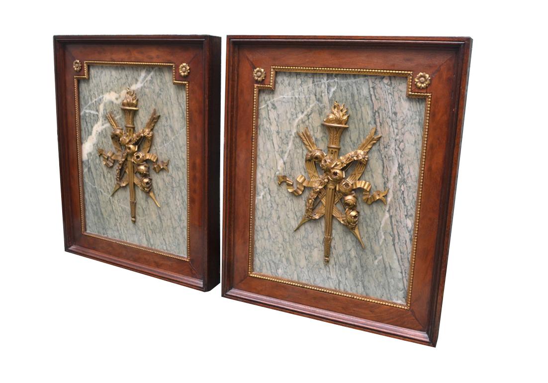 A pair of armorial Ormolu mounts and Turquin grey marble wall plaques presented in mahogany frames with gilded bronze mounts and banding.