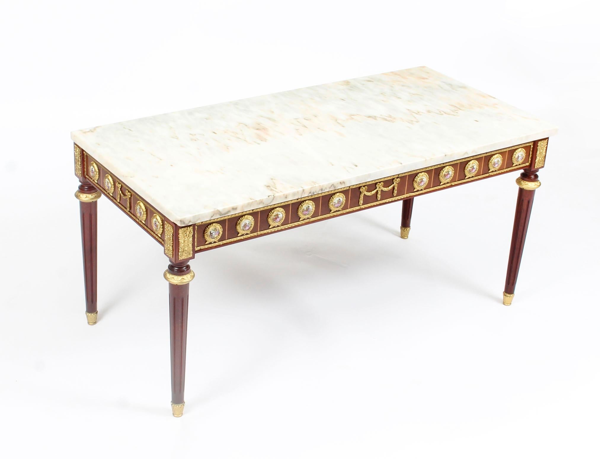 This is an exquisite pair of ormolu-mounted walnut and kingwood marble top coffee tables, mid-century and circa 1950 in date, by the renowned makers H&L Epstein.
  
This wonderful pair of coffee tables are rectangular in shape with elegant and