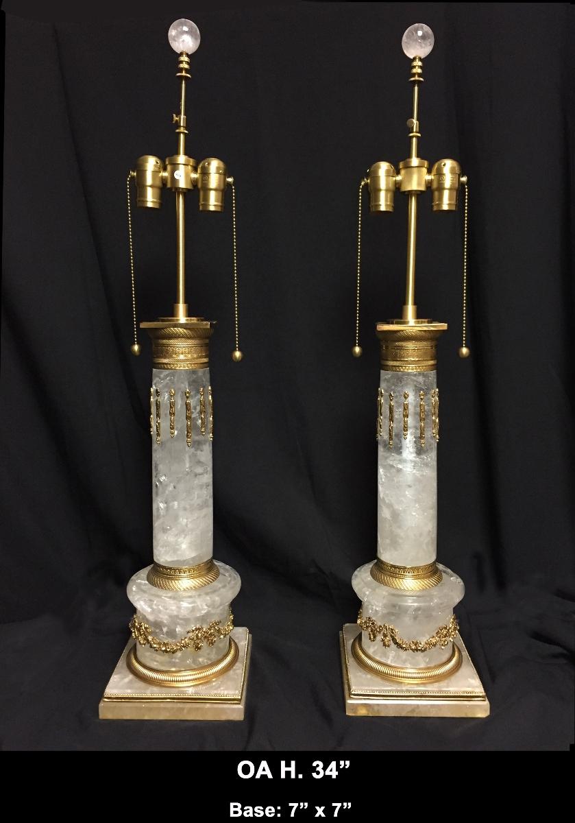 Exceptional large pair of ormolu mounted hand carved rock crystal columnar table lamps with rock crystal finials.
The pair comes with hand gold leafed round shades diameter 18