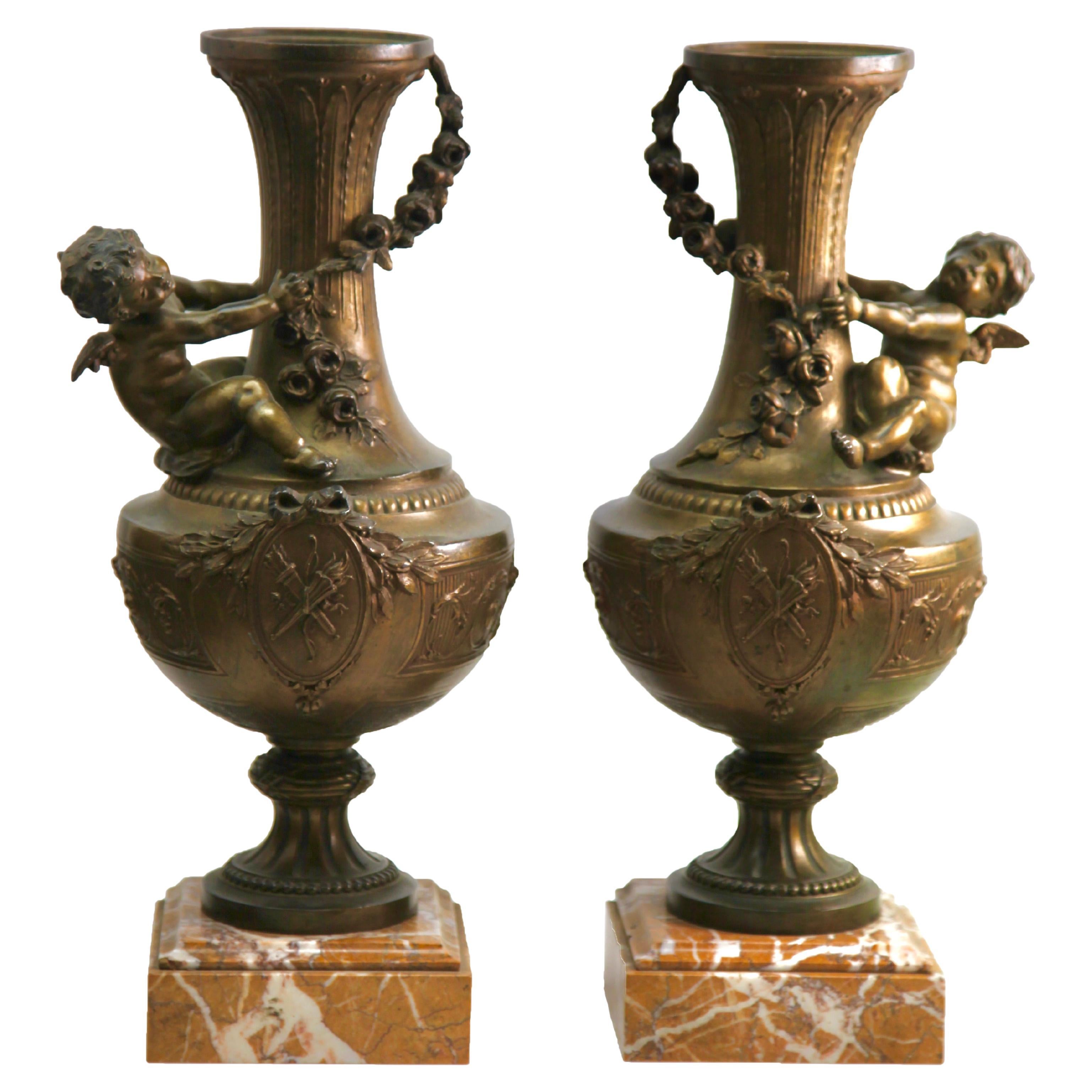 Paar verschnörkelte Vasen oder Lampen mit kleinen Engeln und reich verzierten Motiven im Angebot