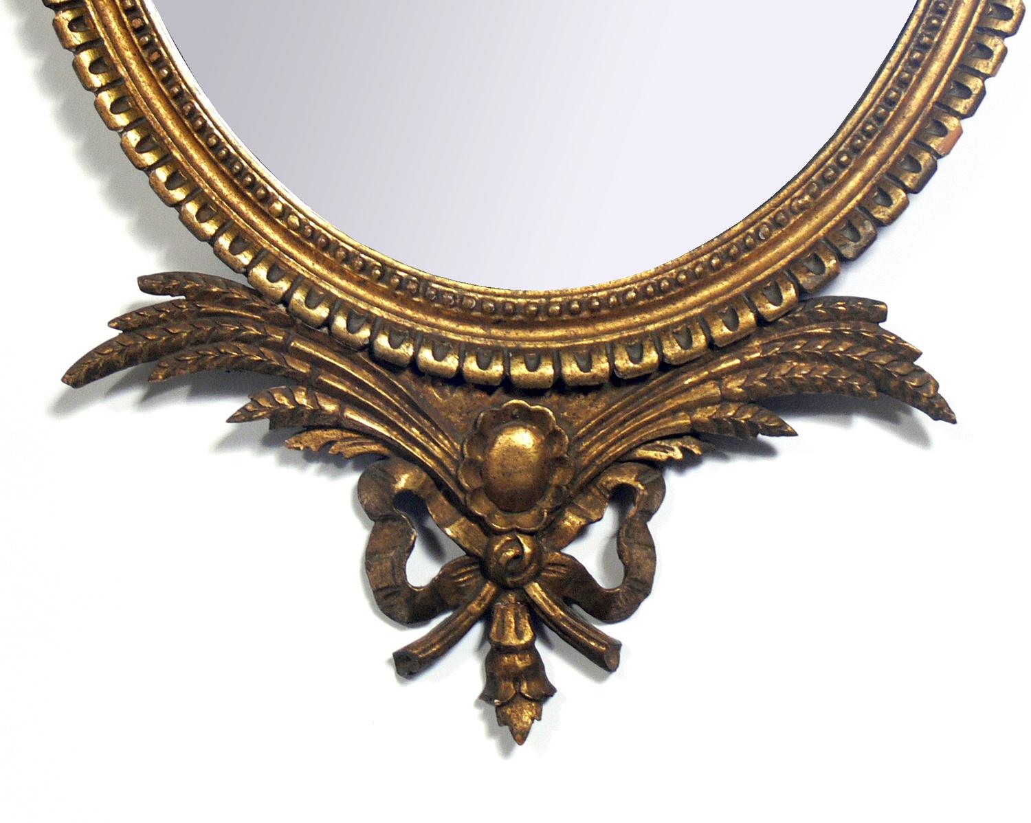 Pair of Ornate Adams style gilt mirrors, possibly Italian, for Friedman Brothers of NYC, American, circa 1940s. They retain their wonderful original patina to both the giltwood frames and the original mirrored glass. They are priced at $1600 each or