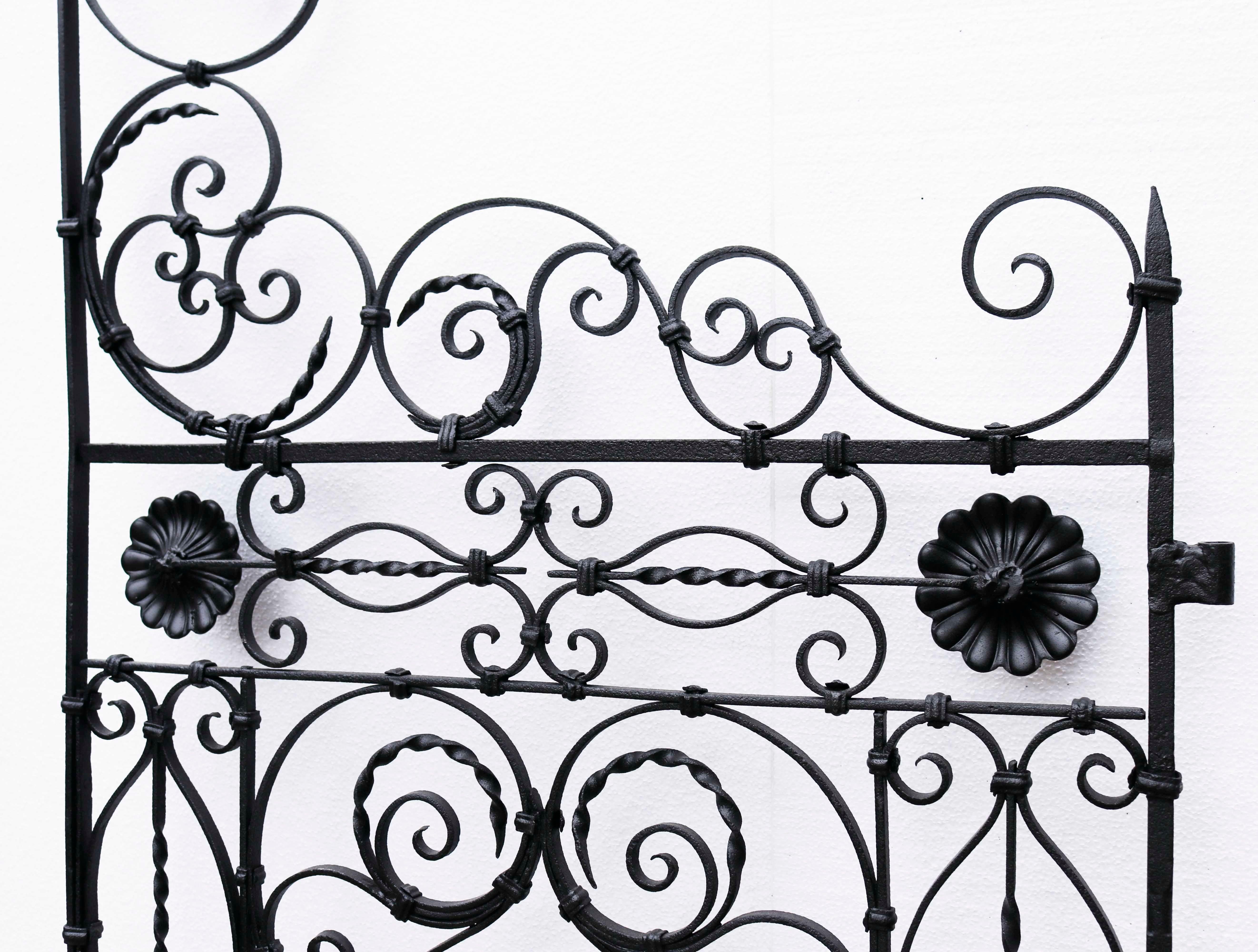 Set of Ornate antique wrought iron gates. A set of tall iron gates with an intricate scrolling pattern. These gates have been fully restored.