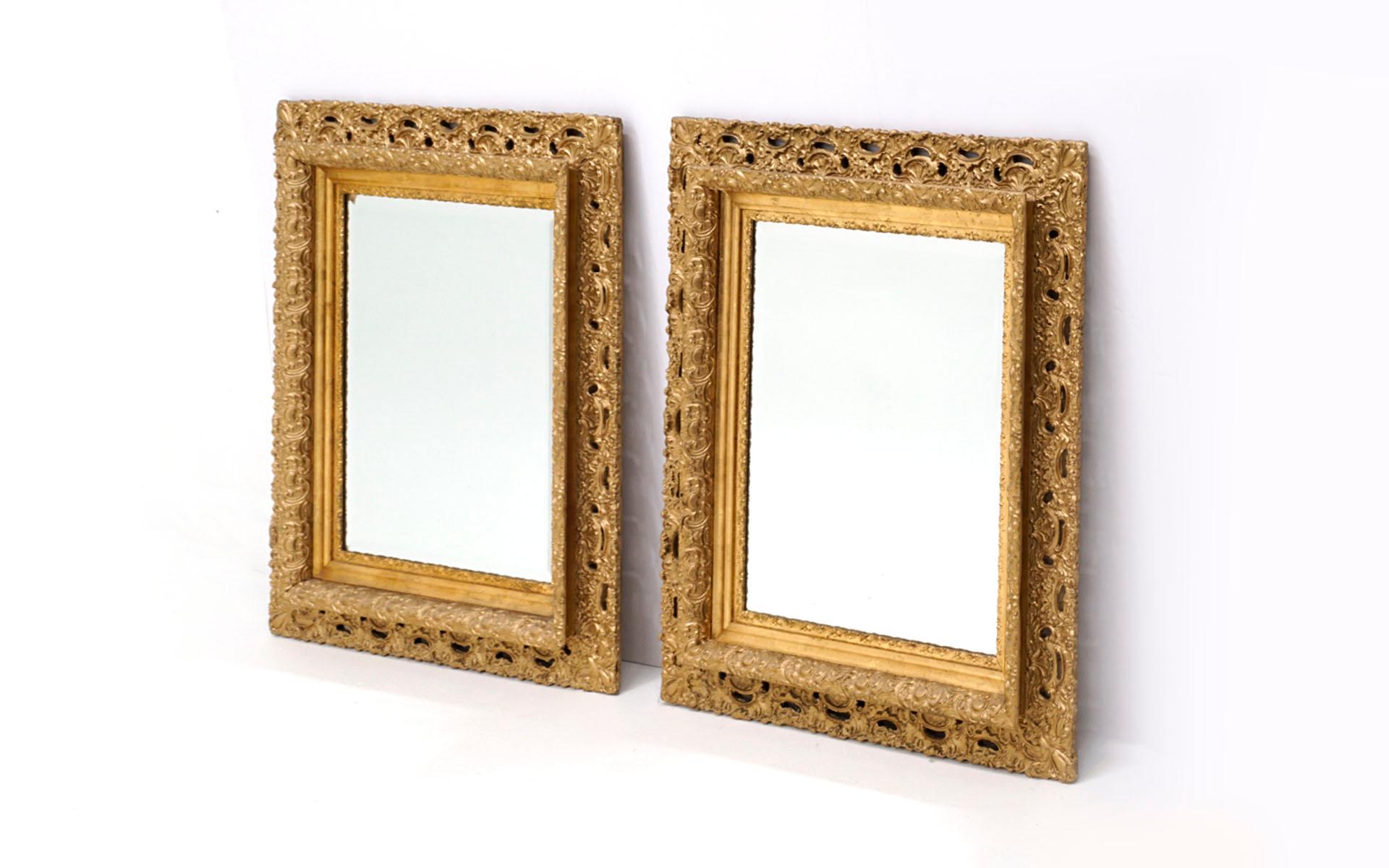 Pair of ornately carved gold gilt framed mirrors in very good to excellent condition.