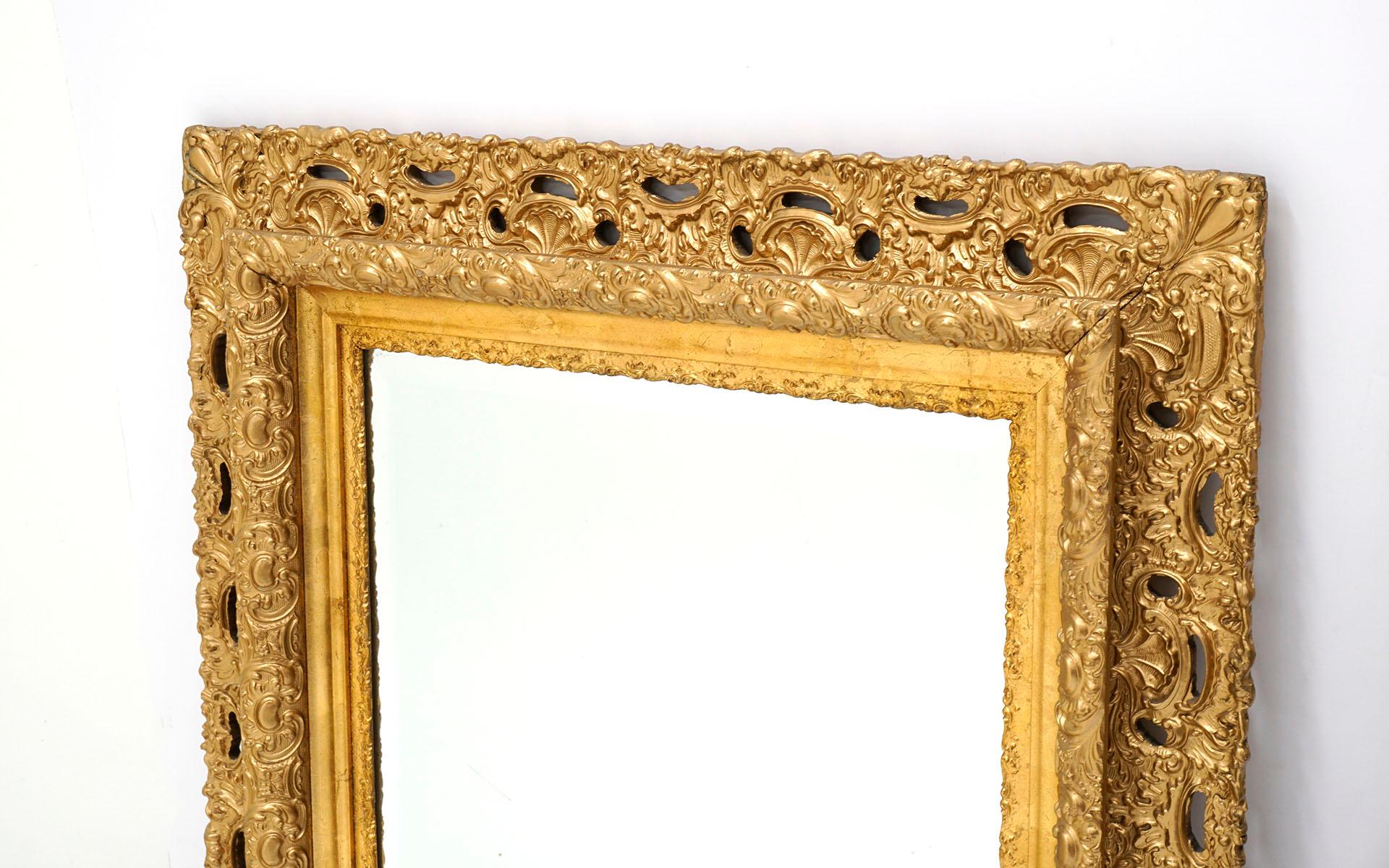 Hollywood Regency Pair of Ornate Gold Giltwood Framed Mirrors For Sale