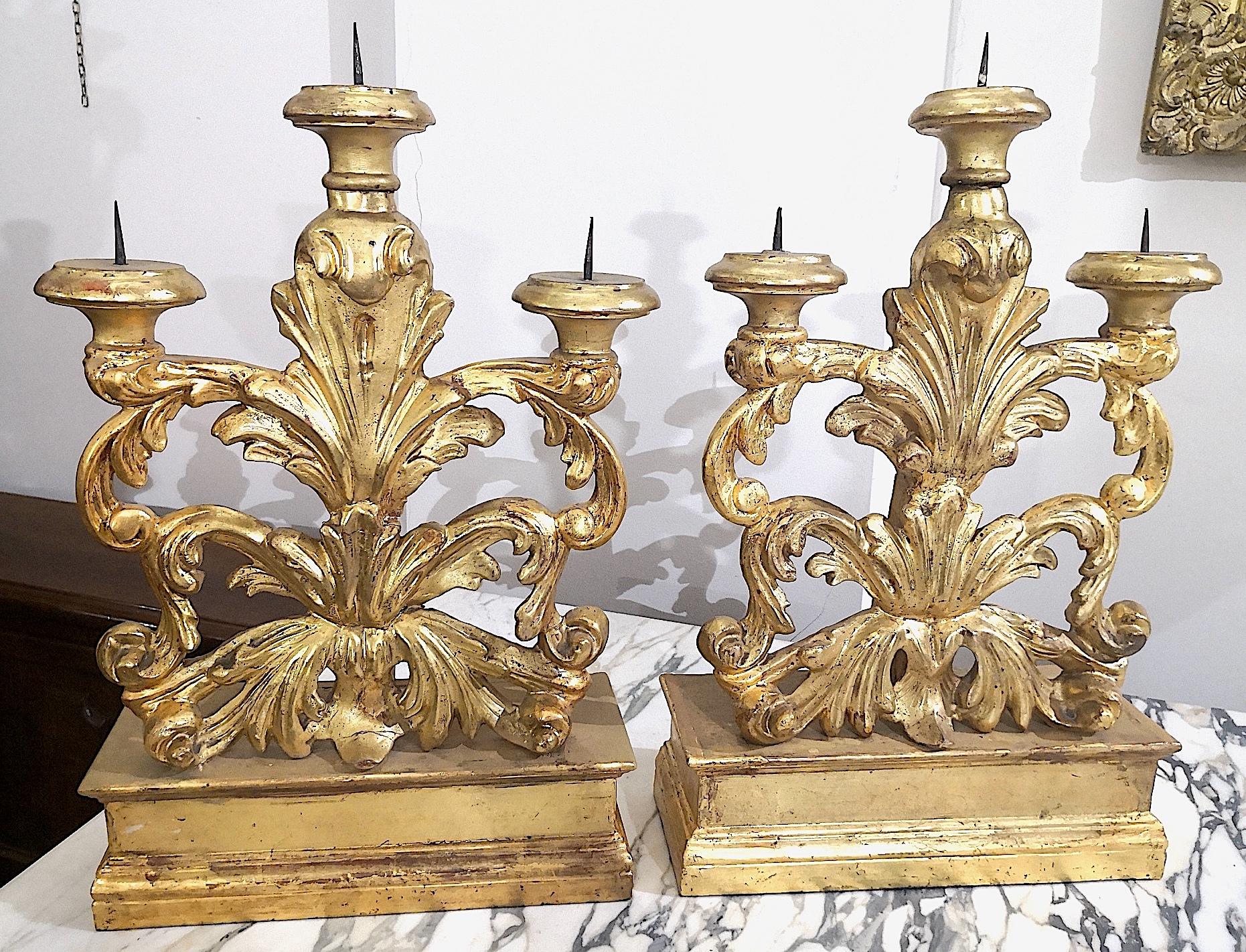 A wonderful pair of ornate Italian Florentine candelabra in the Louis XVI style. They are carved wood with Mecca gold color silver gilding and date from the mid to end of the 18th century. The gilding technique is known as 