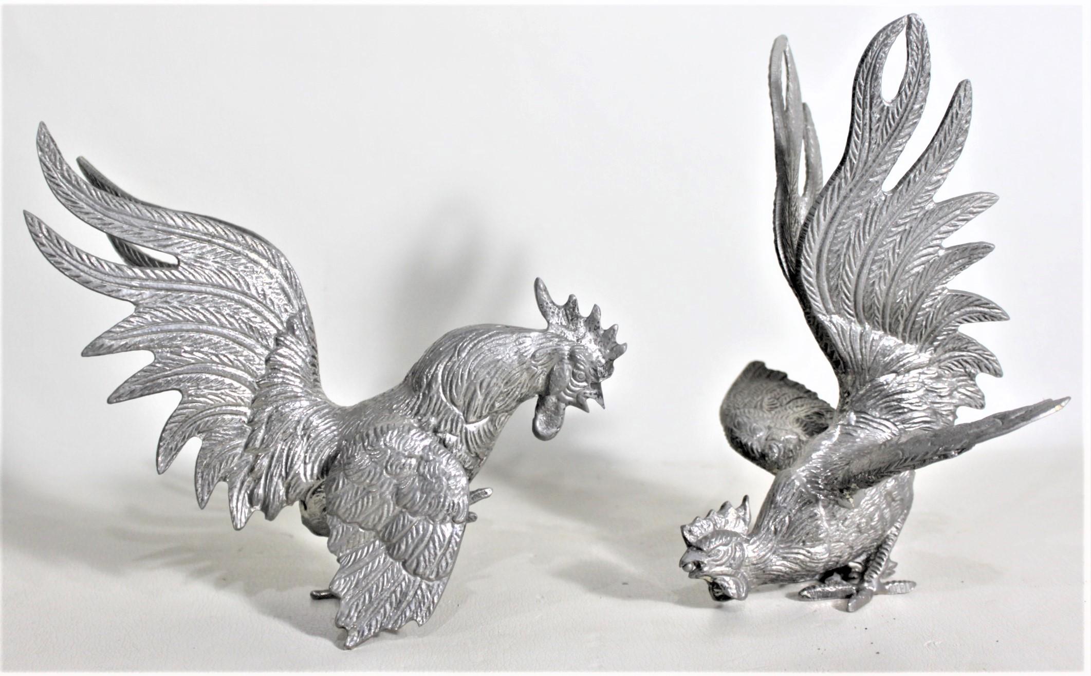 This pair of ornately cast fighting roosters are completely unsigned, but presumed to have originated from Italy and date to approximately 1920 and done in a Victorian style. The well cast roosters are composed of solid brass, with a silver plated