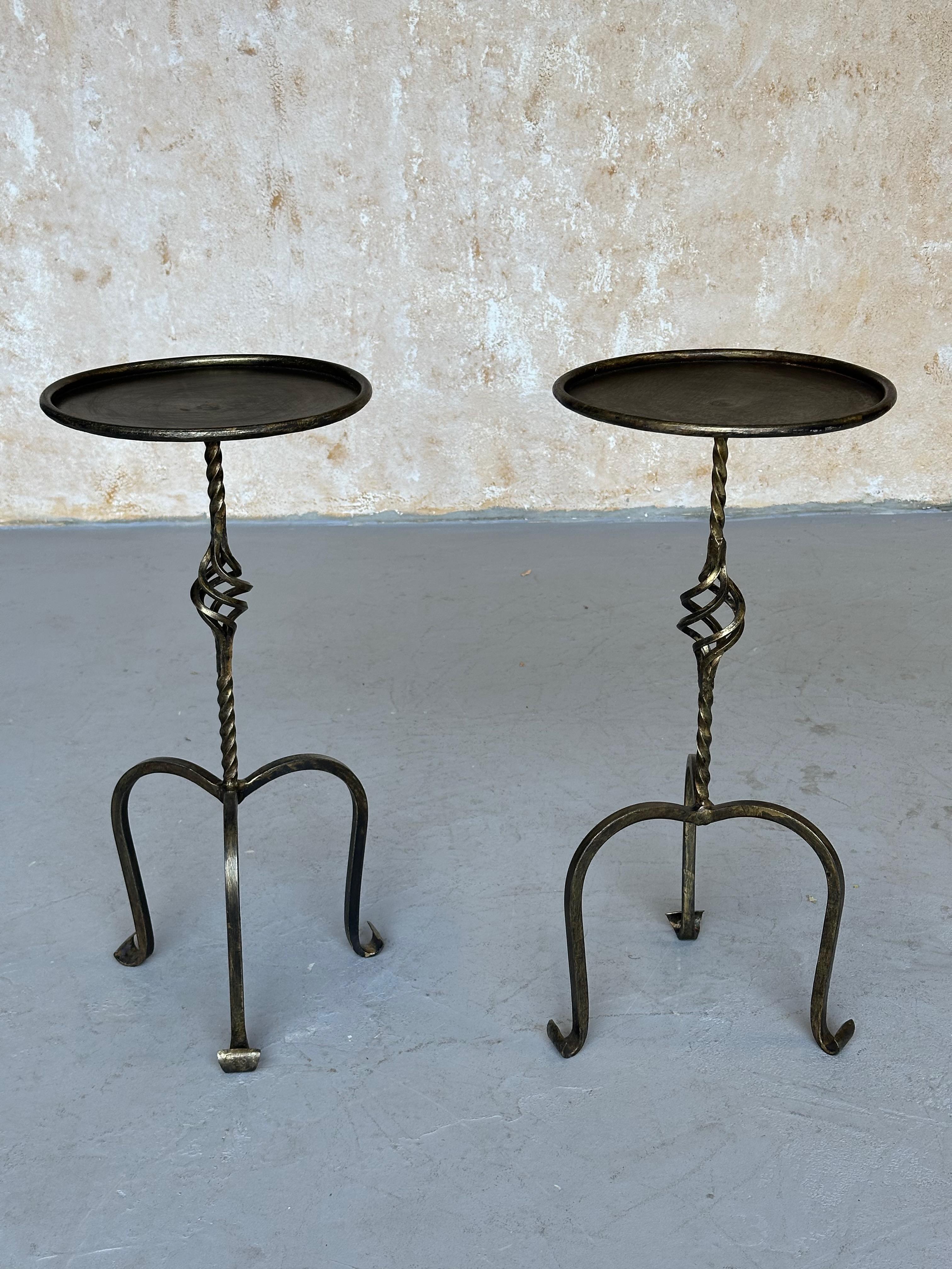 Crafted by skilled European artisans, this exquisite pair of side tables embodies the timeless beauty of traditional ironwork. The twisted stems, ornate central details, and gently scrolled tripod bases exude classic charm. A rolled frame securely