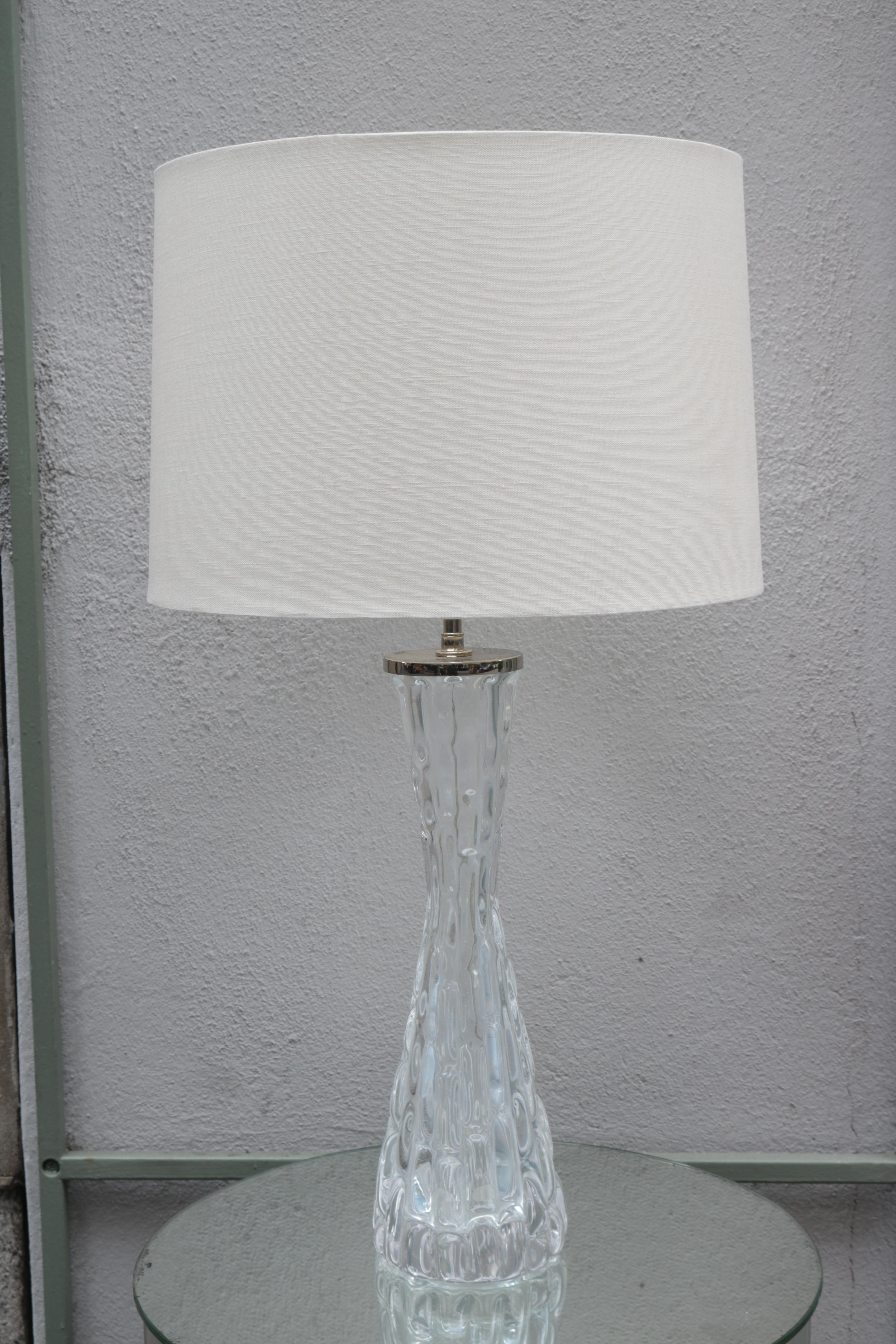 A pair of Orrefors Modernist crystal table lamps with Orrefors signature.
Crystal with chrome details.