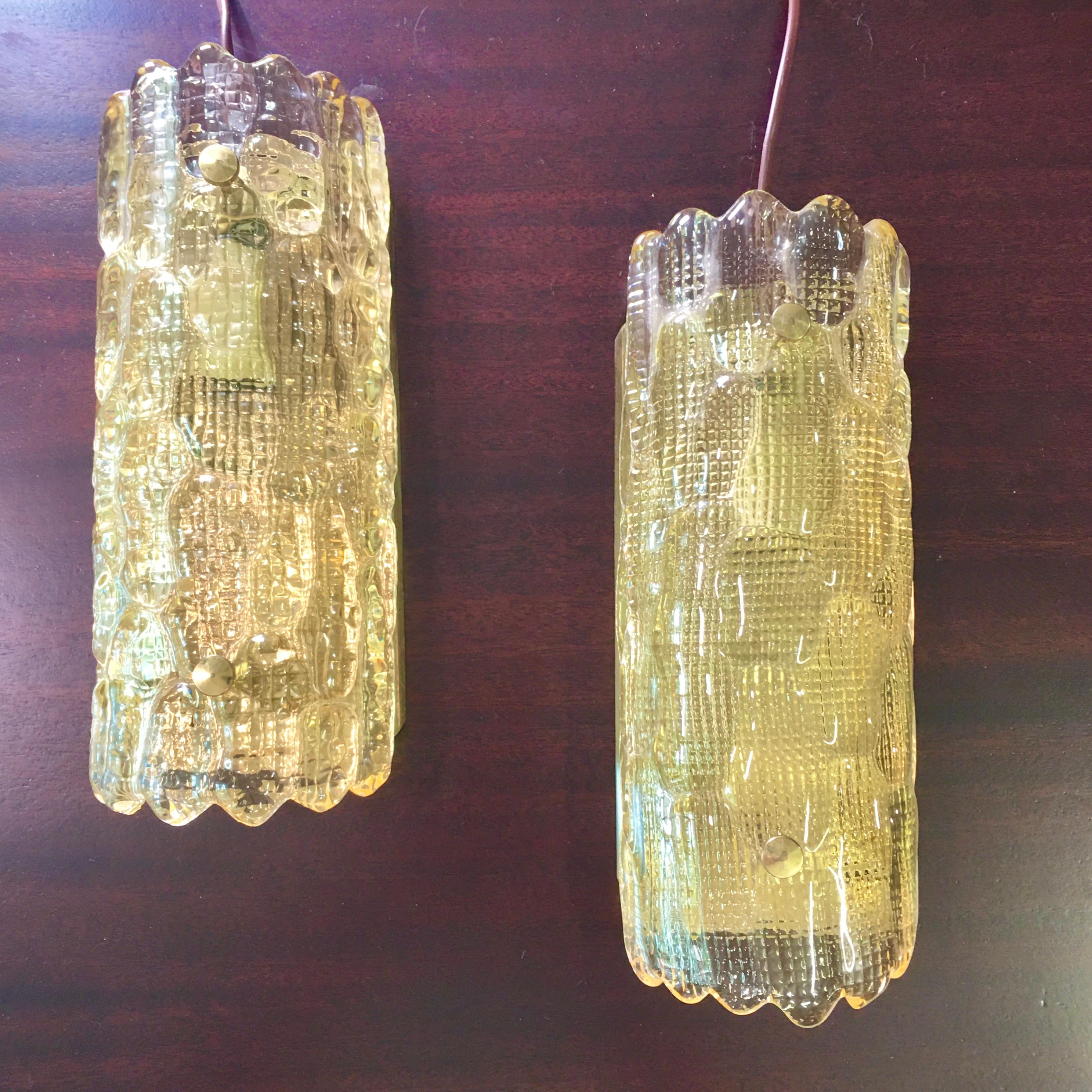 Pair of Large Orrefors Glass Wall Lights / Sconces by Carl Fagerlund  with brass fittings for Orrefors Sweden, signed. 
Currently corded with switch and euro plug. Will convert to be hardwired for USA if requested.