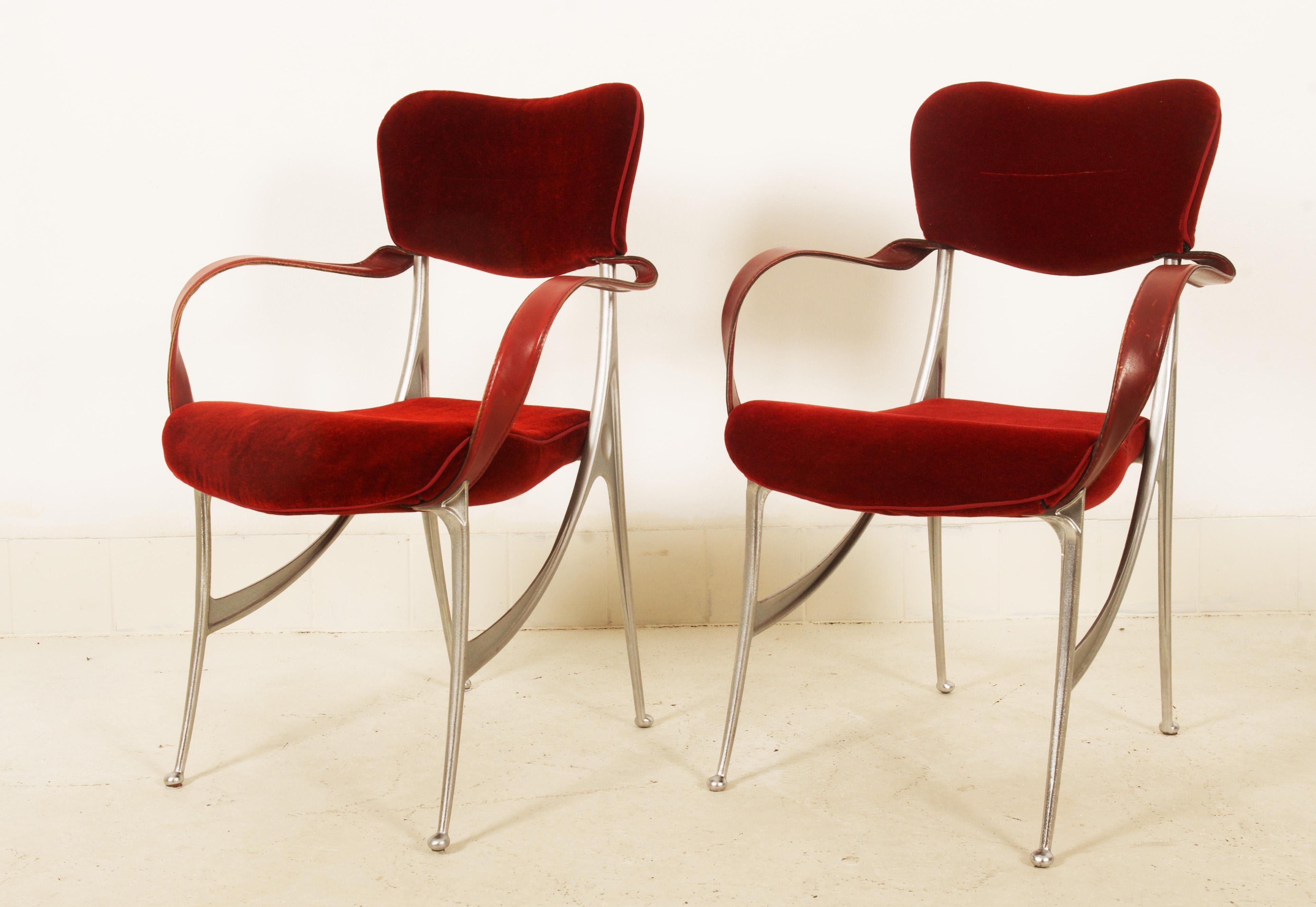Set of two armchairs model Lucas, designed by Oscar Tusquets for Driade. Designed 1987. Organically shaped cast aluminium frames, dark red velvet velour coverings, steel band armrests featuring leather coverings.