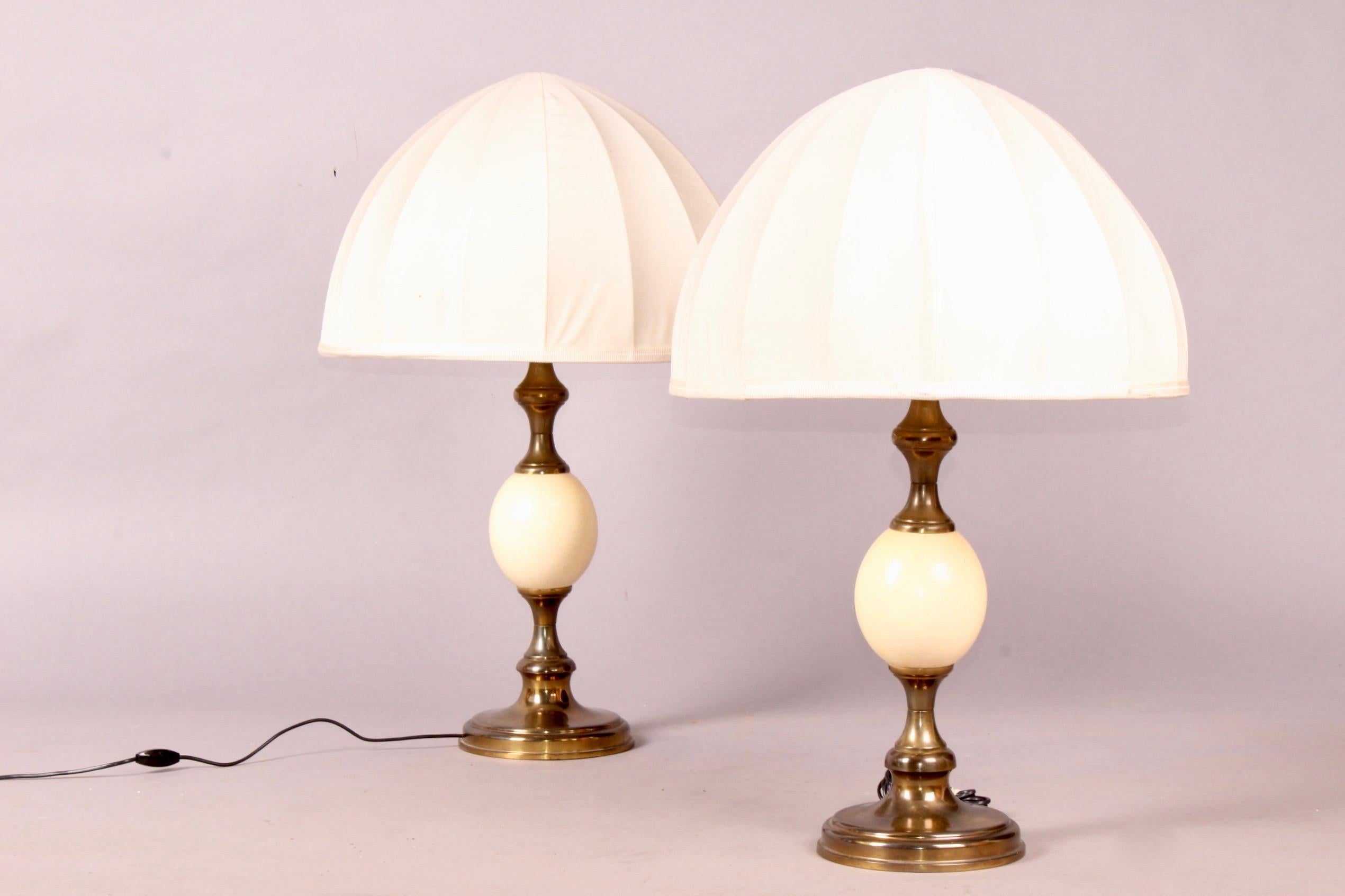 Pair of ostrich egg and brass table lamp, signed RG.