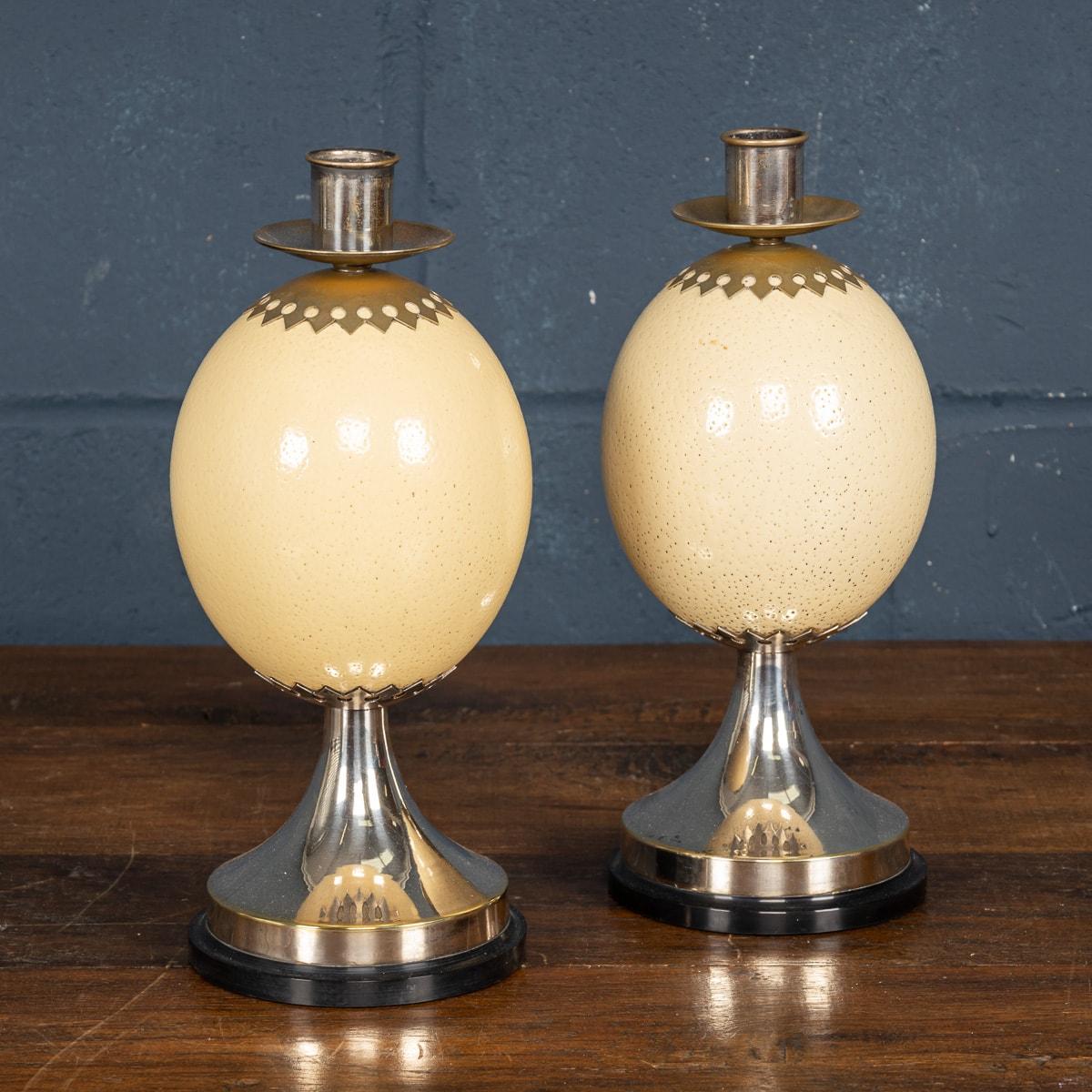 A pair of ostrich egg candlesticks with silver plated mounts by Anthony Redmile. On a two silver plated mounts with an eboby base, impressed and signed J Anthony Redmile to the base, retailed in his shop and purchased in the 1970s.

CONDITION
In