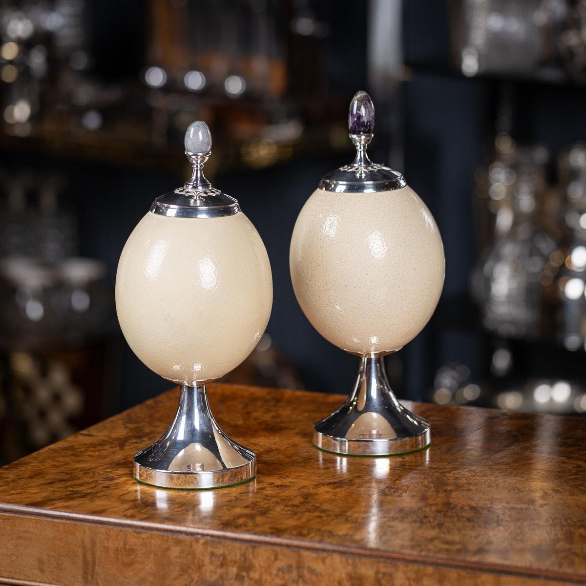 A pair of ostrich egg urns with silver plated mounts and semi precious stone finials by Anthony Redmile. Impressed and signed Redmile London, retailed in his shop and purchased in the 1970s.

Anthony Redmile burst into the London interior design