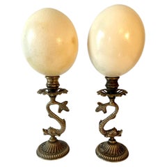 Pair of Ostrich Eggs on Brass Dolphin Bases in the Style of Antony Redmile
