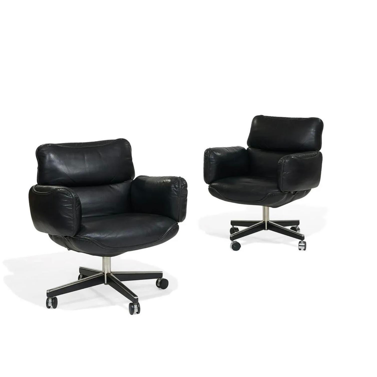 These gorgeous black leather executive management desk chairs are by Otto Zapf for Knoll International, labelled and dated 1974. Constructed of heavily cushioned sections, with the top head section and arms removable. The chair base is height and