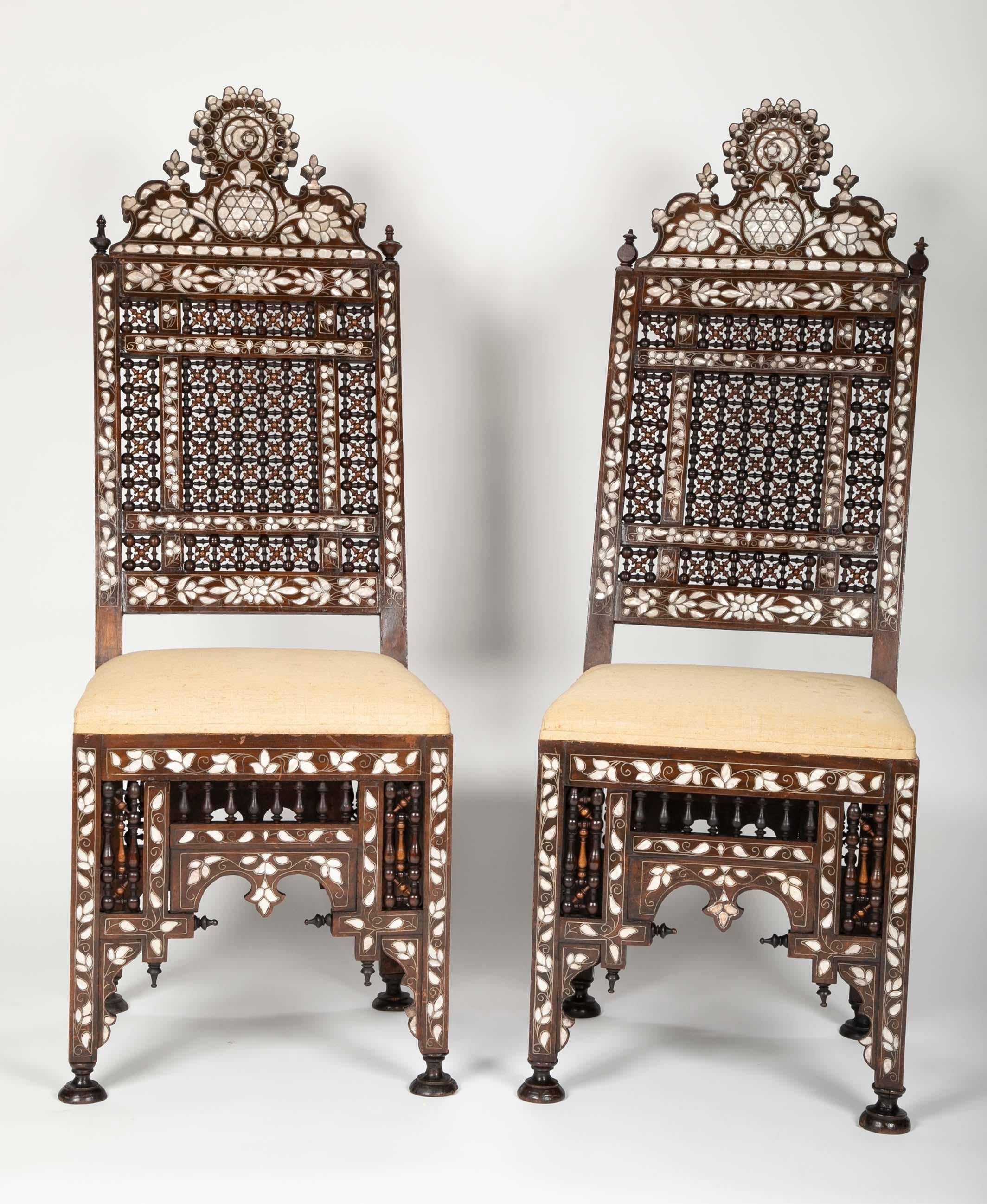 Impressive pair of mother-of-pearl and metal inlaid chairs with intricate hardwood turnings. The skill and time that went into creating these chairs is remarkable. Each with a crest holding the 'star and crescent',
symbol of the Ottoman Empire.