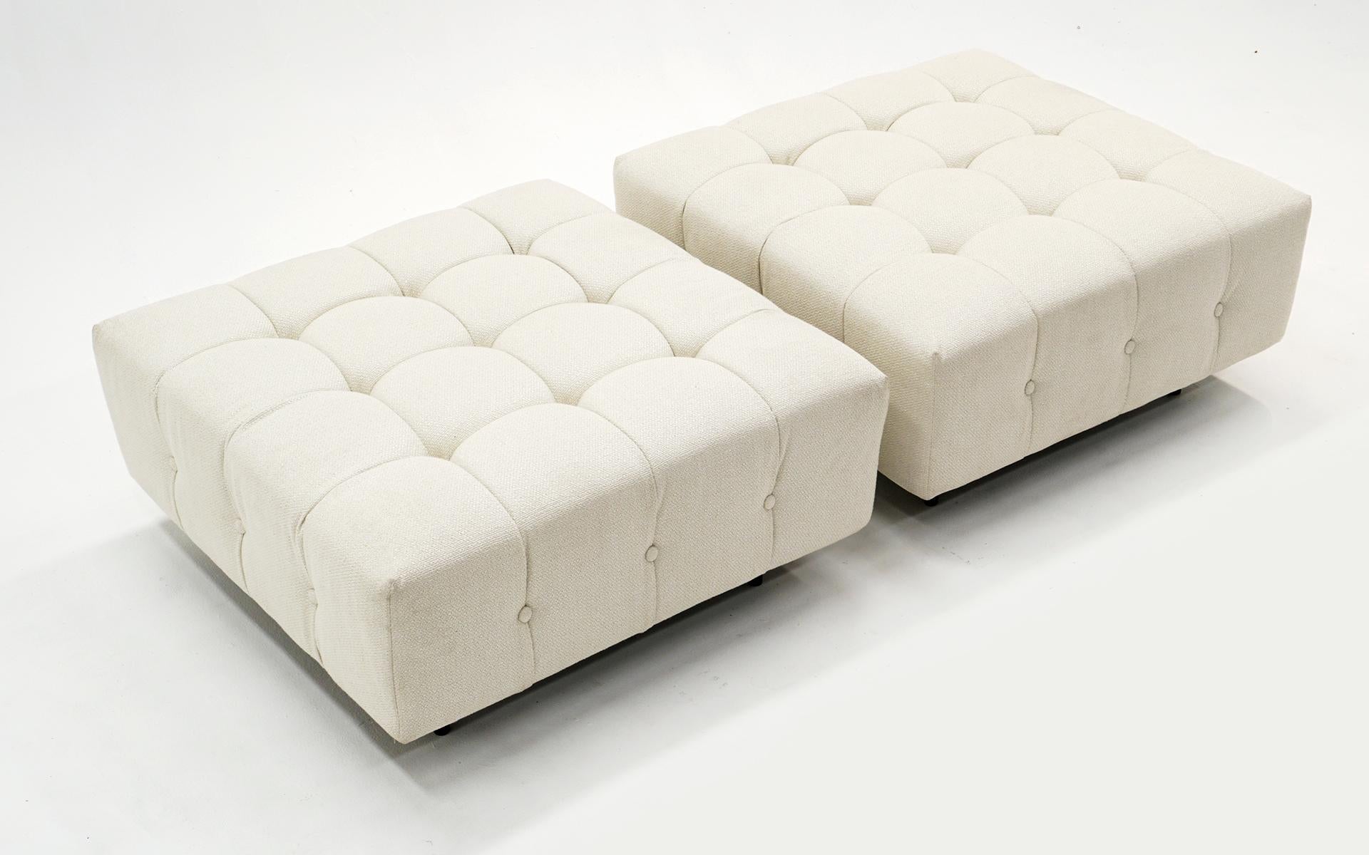 Two matching Harvey Probber ottomans expertly reupholstered in a white / ivory soft blended fabric. The metal black enameled legs show signs of wear and some loss to the finish, but does not detract from the overall appearance. These also function