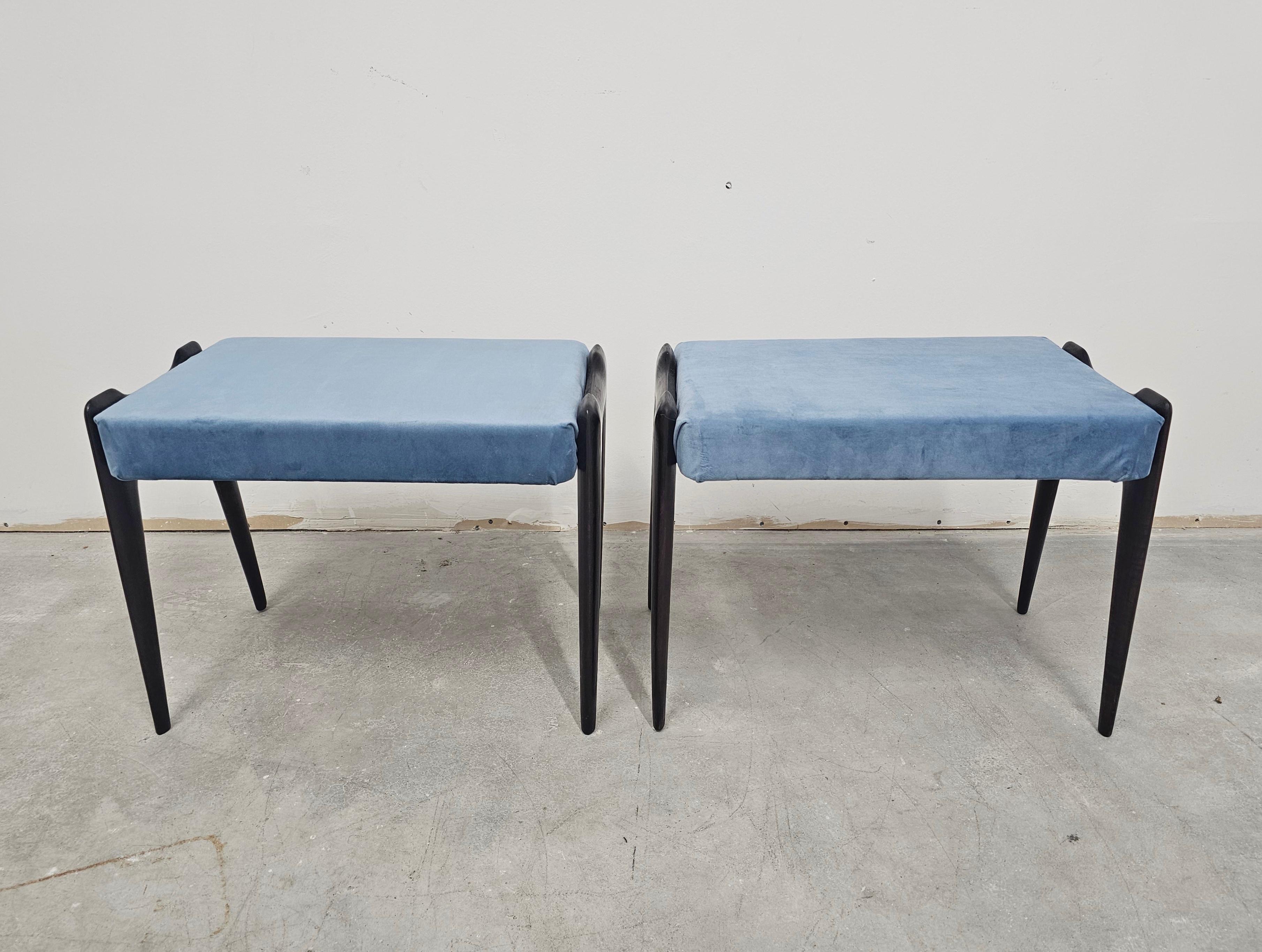 In this listing you will find a pair of Mid Century Modern ottomans or stools designed by the legend of Italian Mid Century Modern design - Ico Parisi. They feature very elegant legs, and have recently been reupholstered by a previous owner in baby