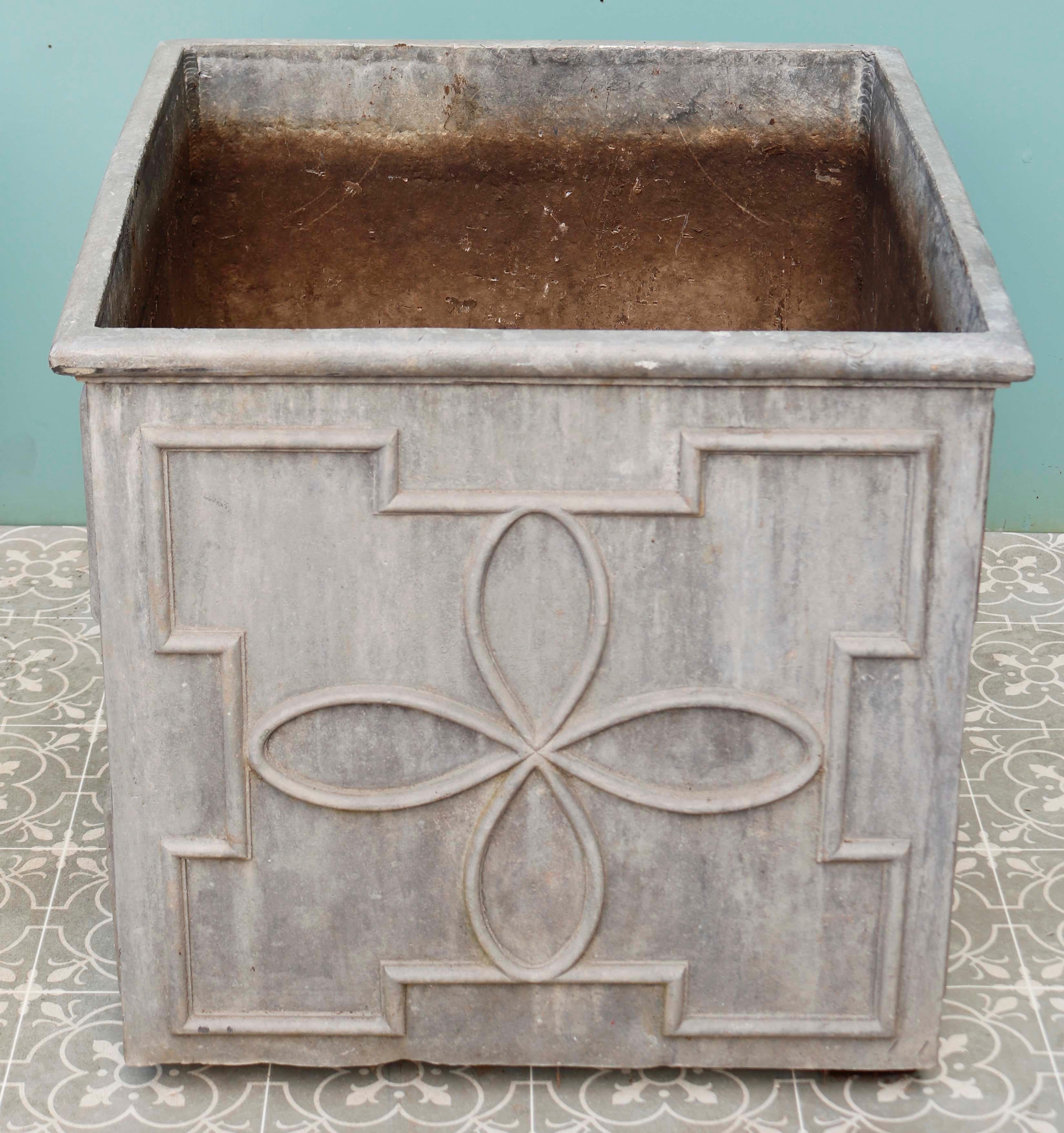 Pair of large lead garden planters. Two vintage lead planters with finely worked floral patterns. Both include drainage holes for plants making them practical as well as visually appealing. The last image shows the planters in situ at Abbey House