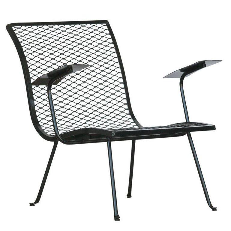 Pair of black tubular steel and metal grate outdoor or patio lounge chairs with flat metal armrests by Karl Lightfoot Studio. The chair displays the simple yet elegant design Karl Lightfoot became famous for in the Mid-century movement of the 1950s.