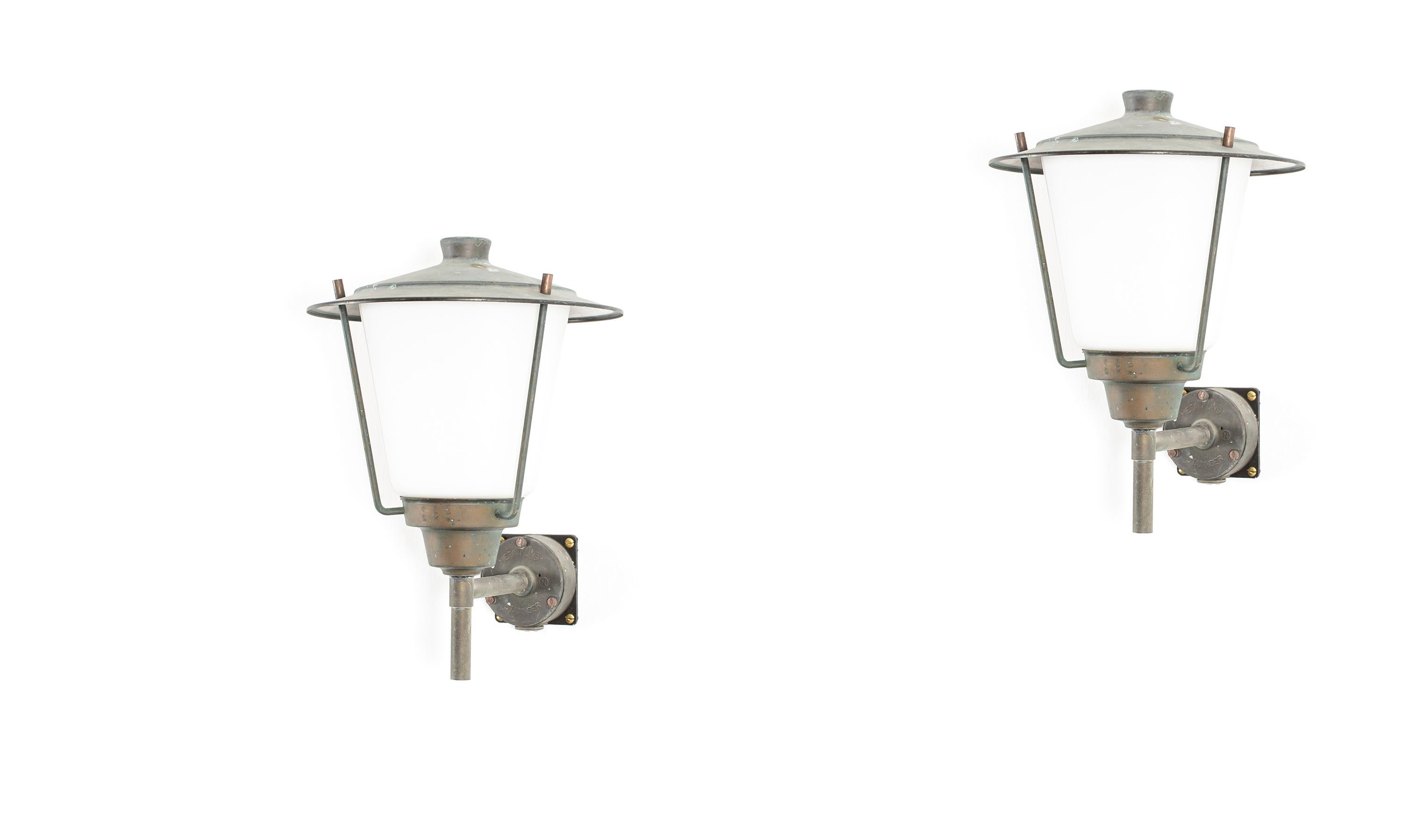 Modernist pair of outdoor wall lamps in patinated copper and opaline glass. Designed and made in Norway from circa 1960s second half. Both lamps are fully working and in good vintage condition. The lamps are fitted with one E27 bulb holder (works in