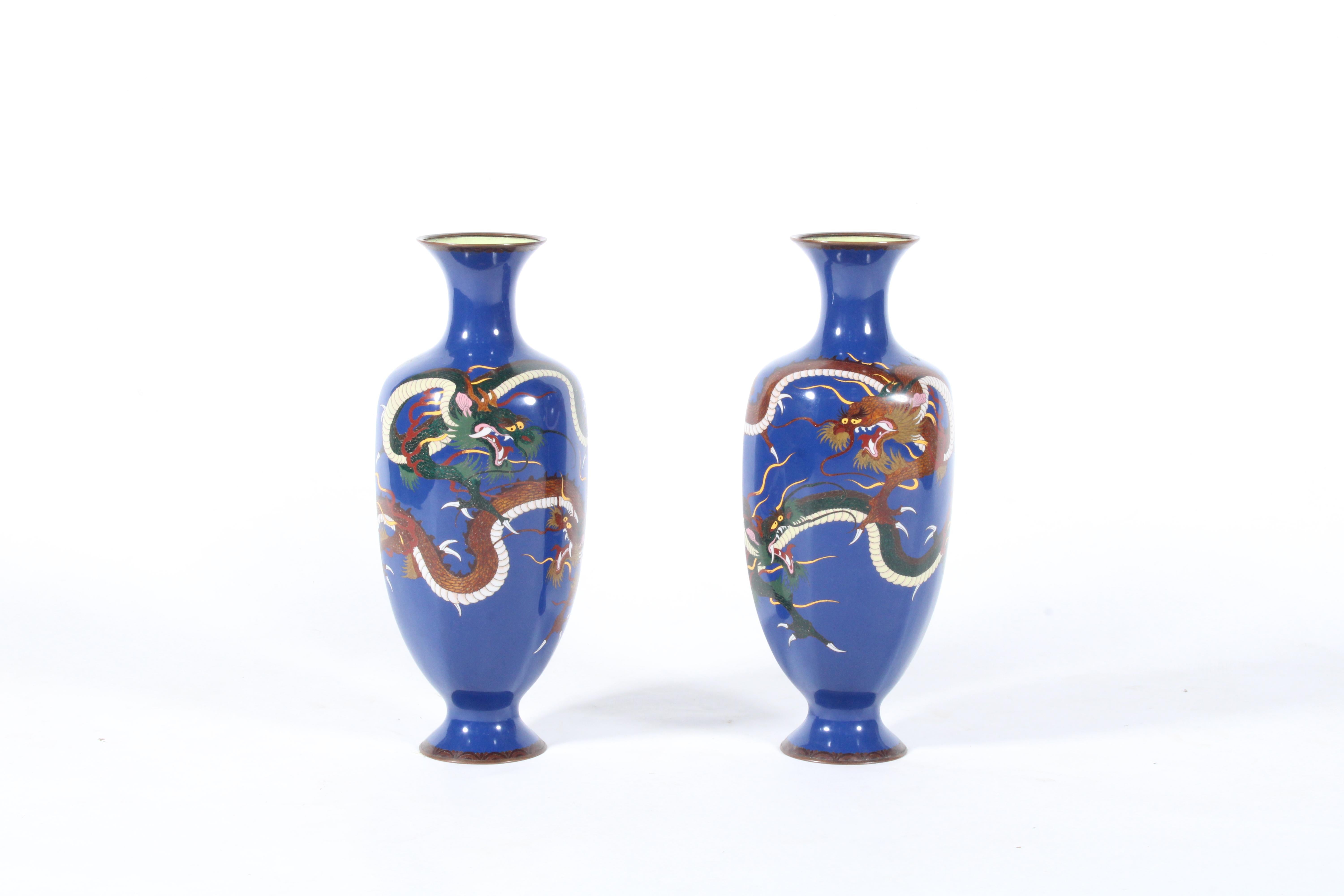 An incredible pair of enameled cloisonné Japenese vases. Dating from circa 1950 this stunning duo are both tactile and incredibly decorative, the perfect pair to dress your sideboard or console table and to create a real design impact in your home