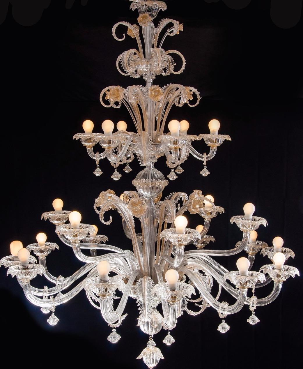 Spectacular pair of Murano chandeliers. The arms 24 are arranged on three floors. The glasses are embellished with gold inclusions.
We can wire the chandelier with candle light holders. 
Provenance from an important Roman palace.
 
This light