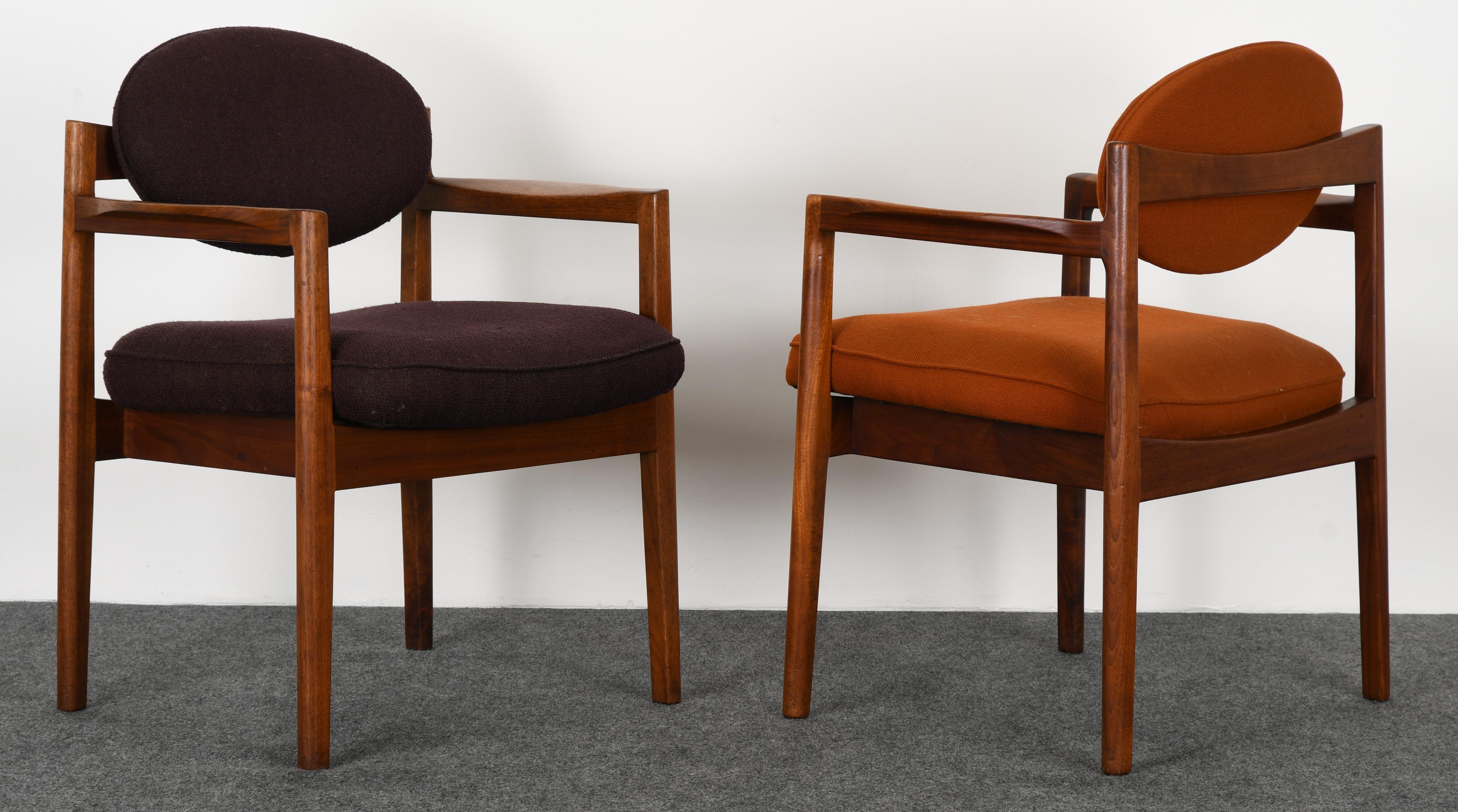 A sculptural pair of oval back armchairs by Jens Risom, 1960s. The chair frames are in good original condition. These retail new through Ralph Pucci International for $3,600 each. Marked with Risom insignia underside, as shown in images. New