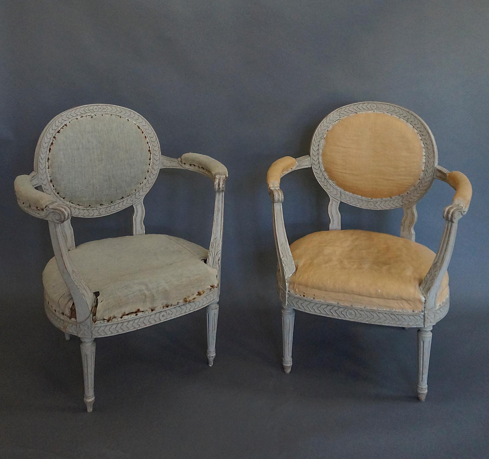 Pair of Gustavian style armchairs, Sweden, circa 1900, with oval backs and flared arms. Chain molding around the oval back and seat. Tapering round legs. Very comfortable.