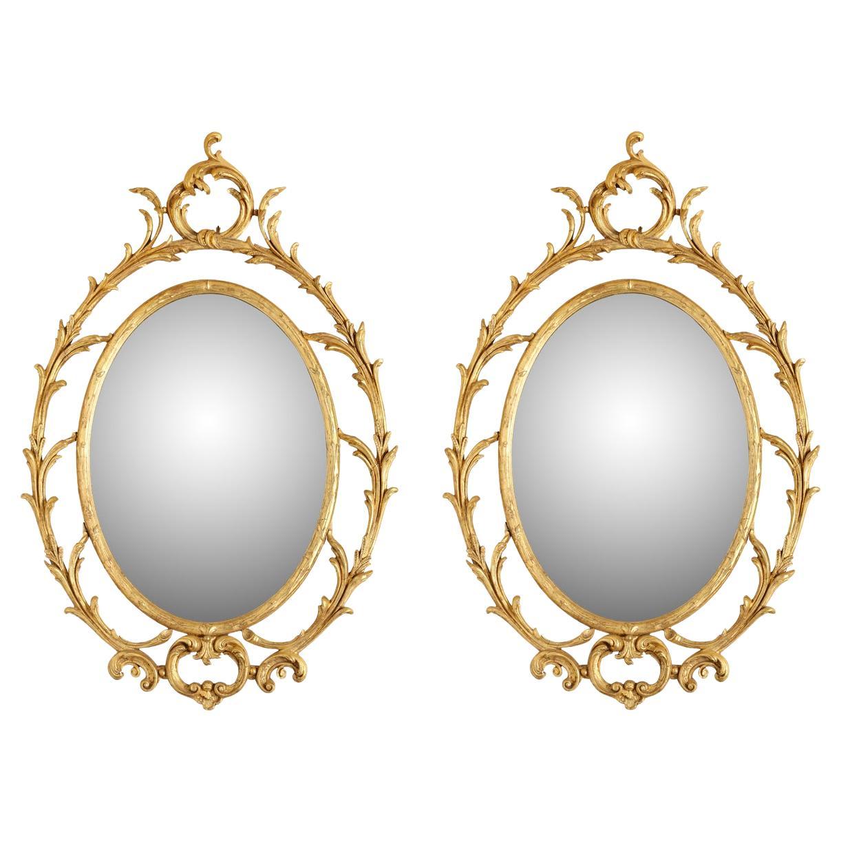 Pair of Oval Giltwood Mirrors With Scroll Motif