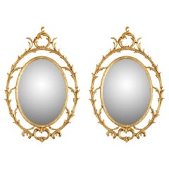 Pair of Oval Giltwood Mirrors With Scroll Motif