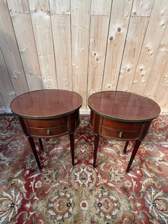 Pair of oval Louis XVI bedside tables in mahogany
