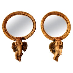 Vintage Pair of Oval Mirrors Polychromed and Held by Winged Cherub