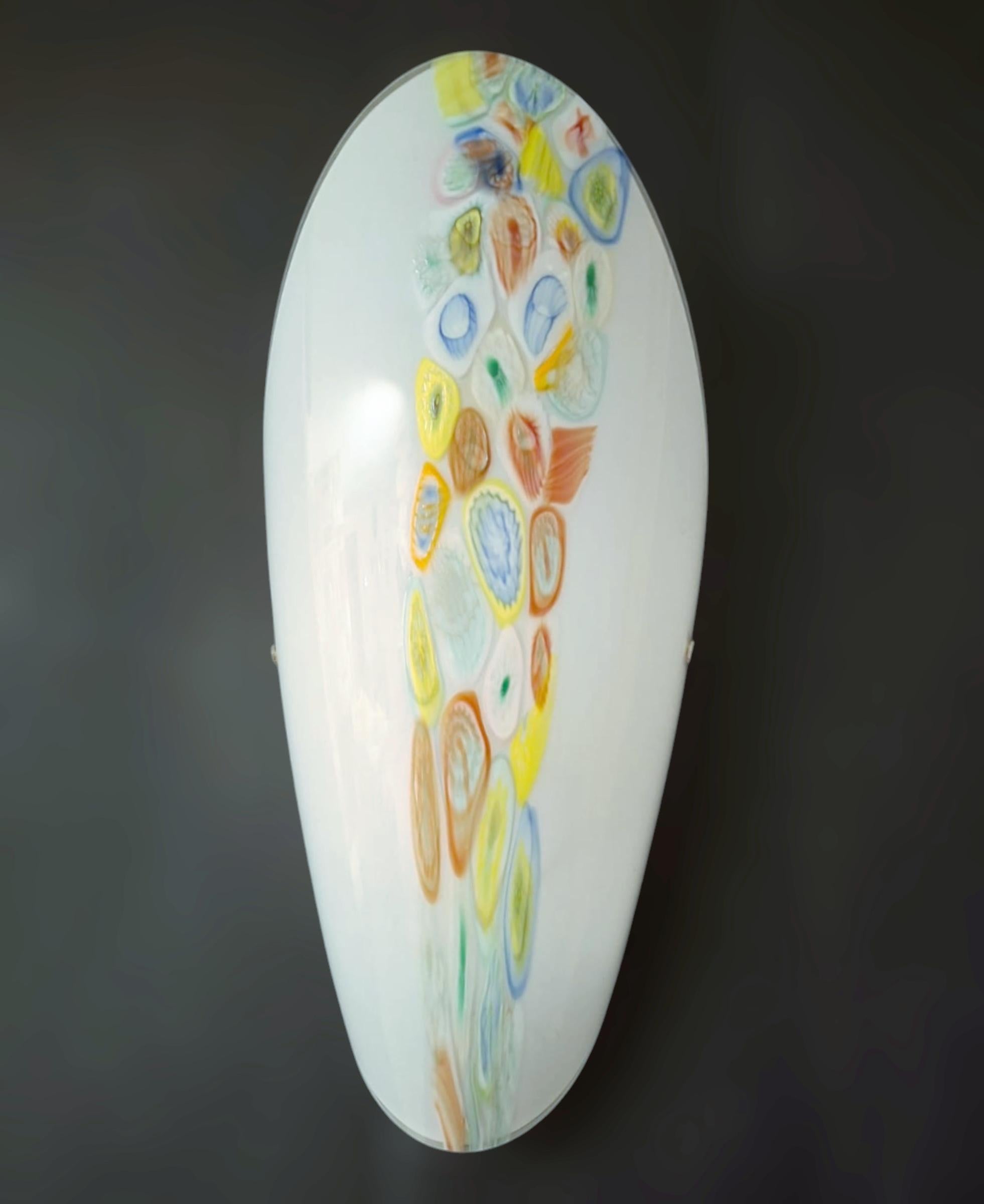 Vintage Italian wall lights with milky white oval shaped Murano glass shades hand blown with multicolored Murrine / Made in Italy, circa 1960s
Measures: height 17.5 inches, width 9 inches, depth 5 inches
1 light / E26 or E27 type / max 60W
1 pair