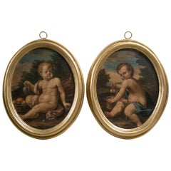 Pair of Oval Oil on Canvas Paintings of Putti