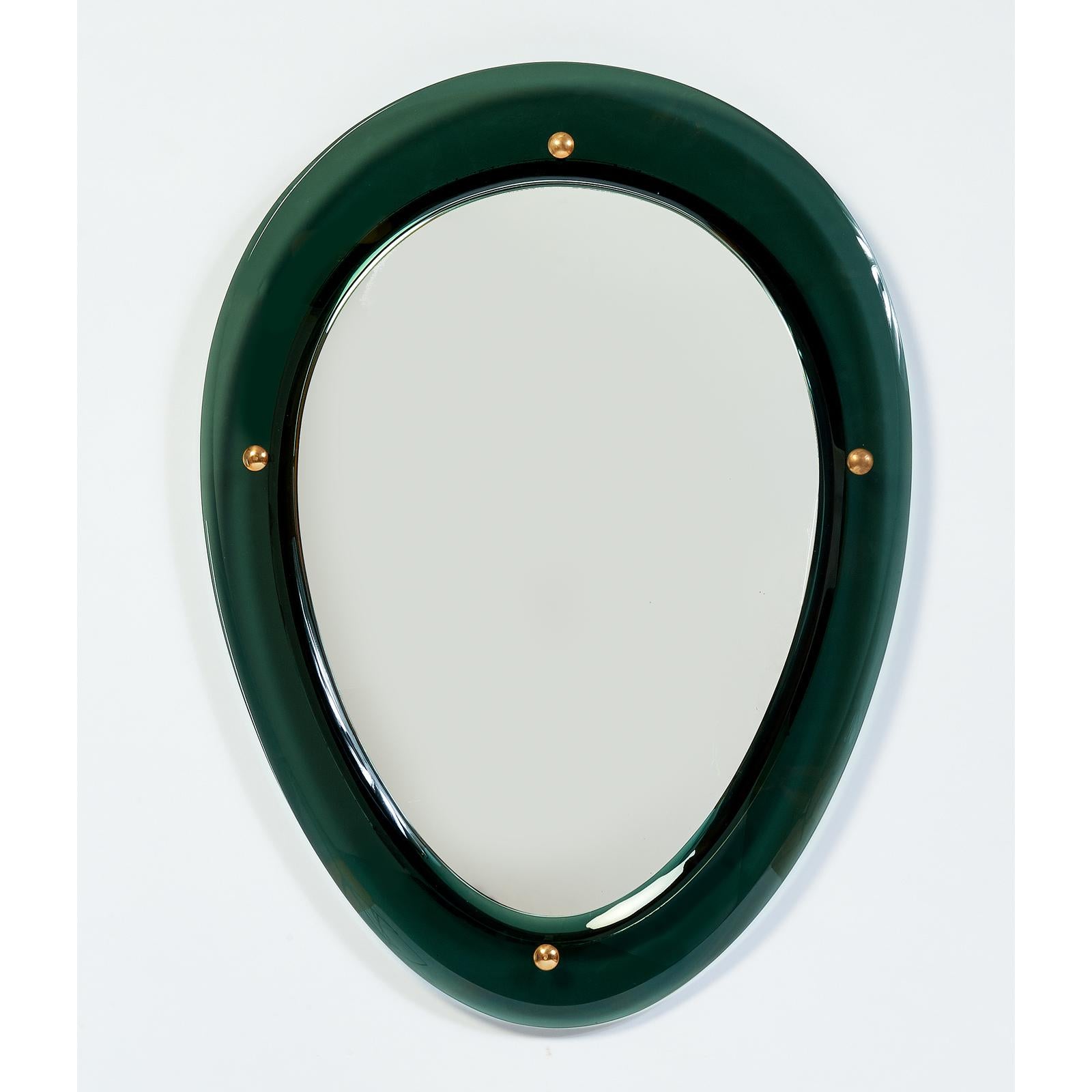 Italy, 1950s
Exquisite pair of oval shaped colored glass mirrors,
with beveled glass frames mounted on mirrored glass, 
with four brass mounts.
Dimensions: 25 W x 33 H x 1 D
On one of the two mirrors corrosion of silvering, see last image.
SOLD AND