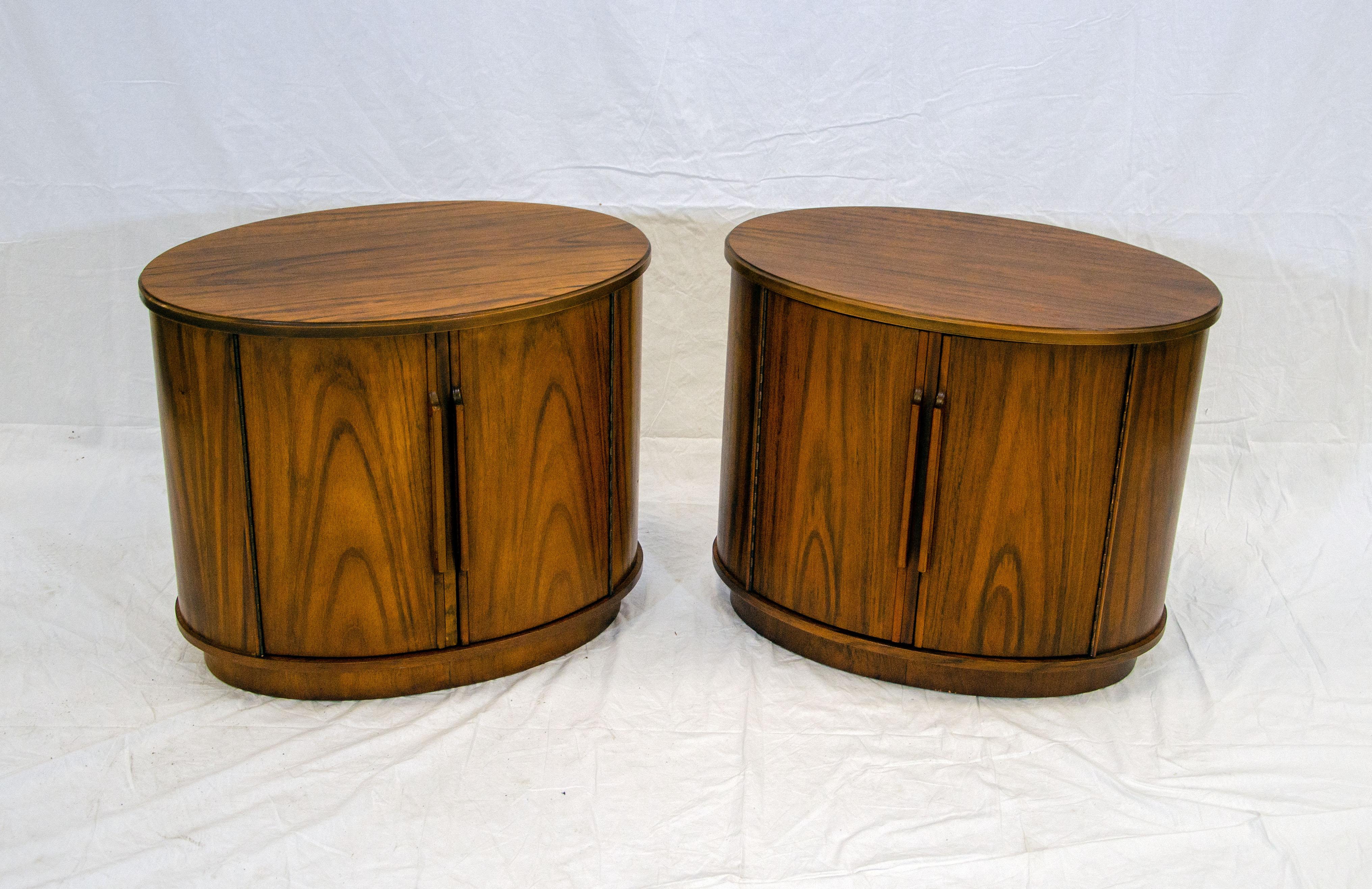 Unusual oval-shaped pair of nightstands or end tables from the Heritage Furniture division of Drexel. There are two doors that have a width of 17 1/2