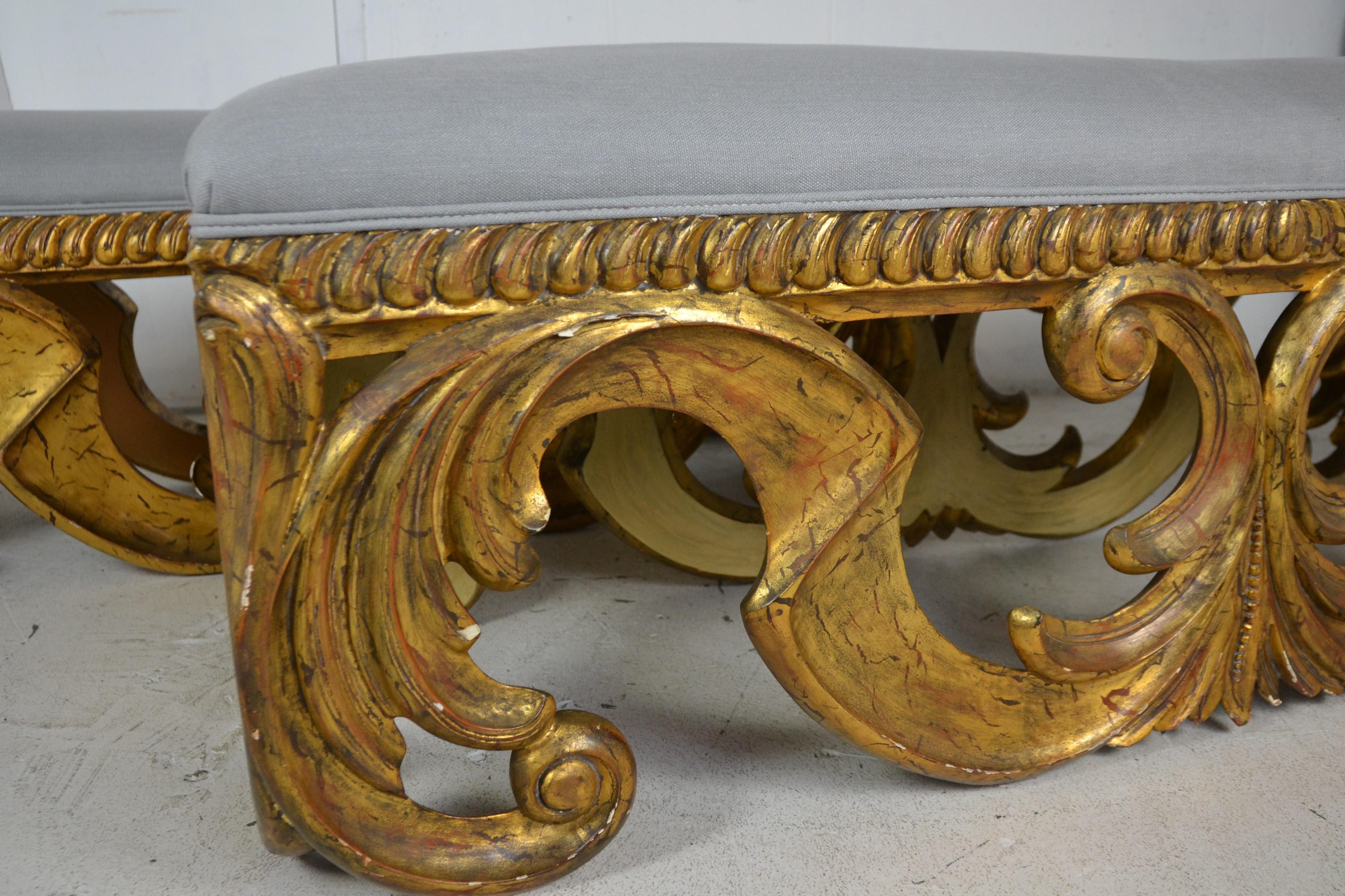 Pair of wood carved gilded oversize benches . Newly upholstered in Belgium linen.