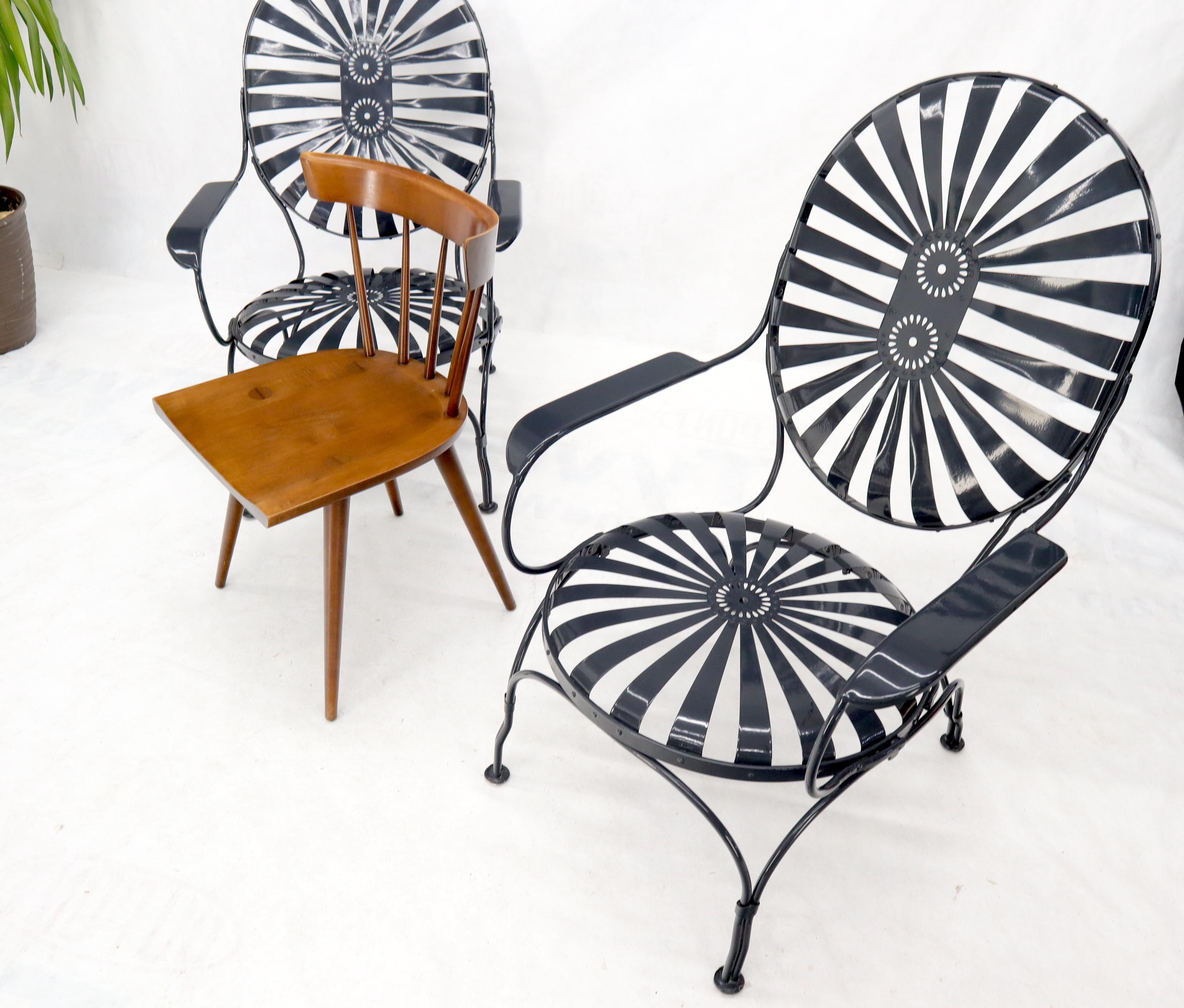 Pair of Mid-Century Modern oversize sunburst lounge chairs by Francois Carre. Restored mint condition. Offers very comfortable outdoor maintenance free seating.