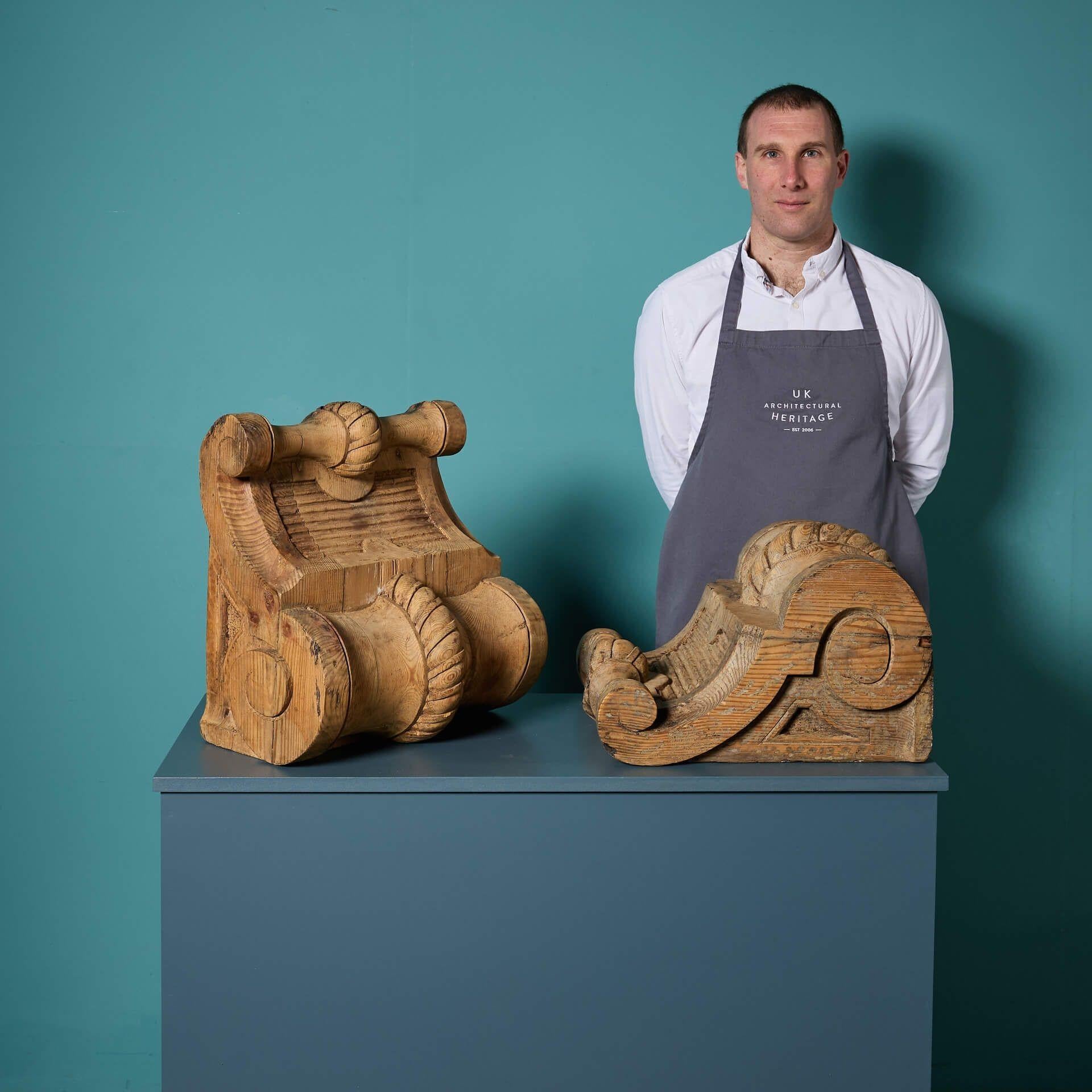 An unusual and whimsical pair of oversized antique English carved pine corbels dating from the Georgian period, circa 1830.

Once architectural elements, these substantial handcarved wooden corbels today have a number of uses – from decorative porch