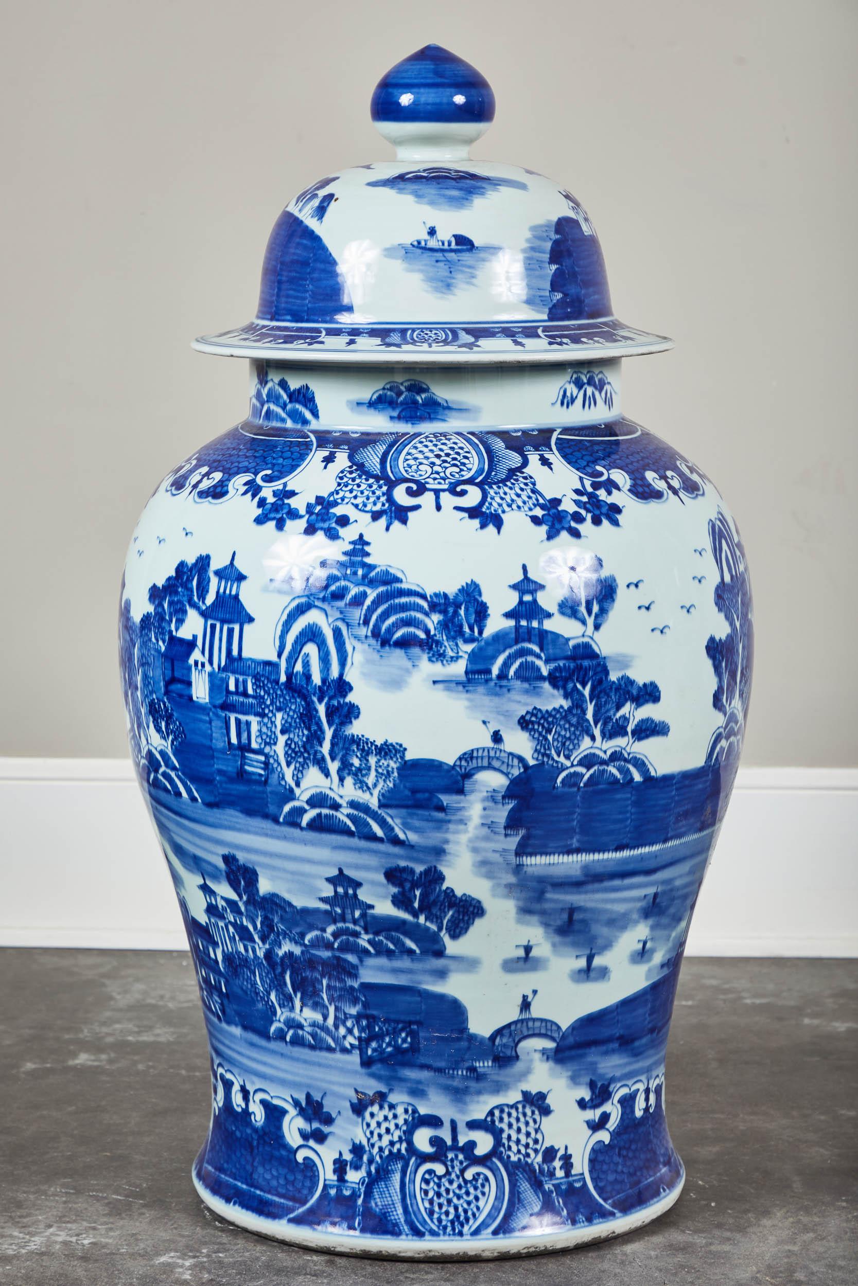 A pair of mid-20th century oversized blue and white Chinese jars with lids. Large in scale, would look stunning on pedestals or flanking a fireplace surround.