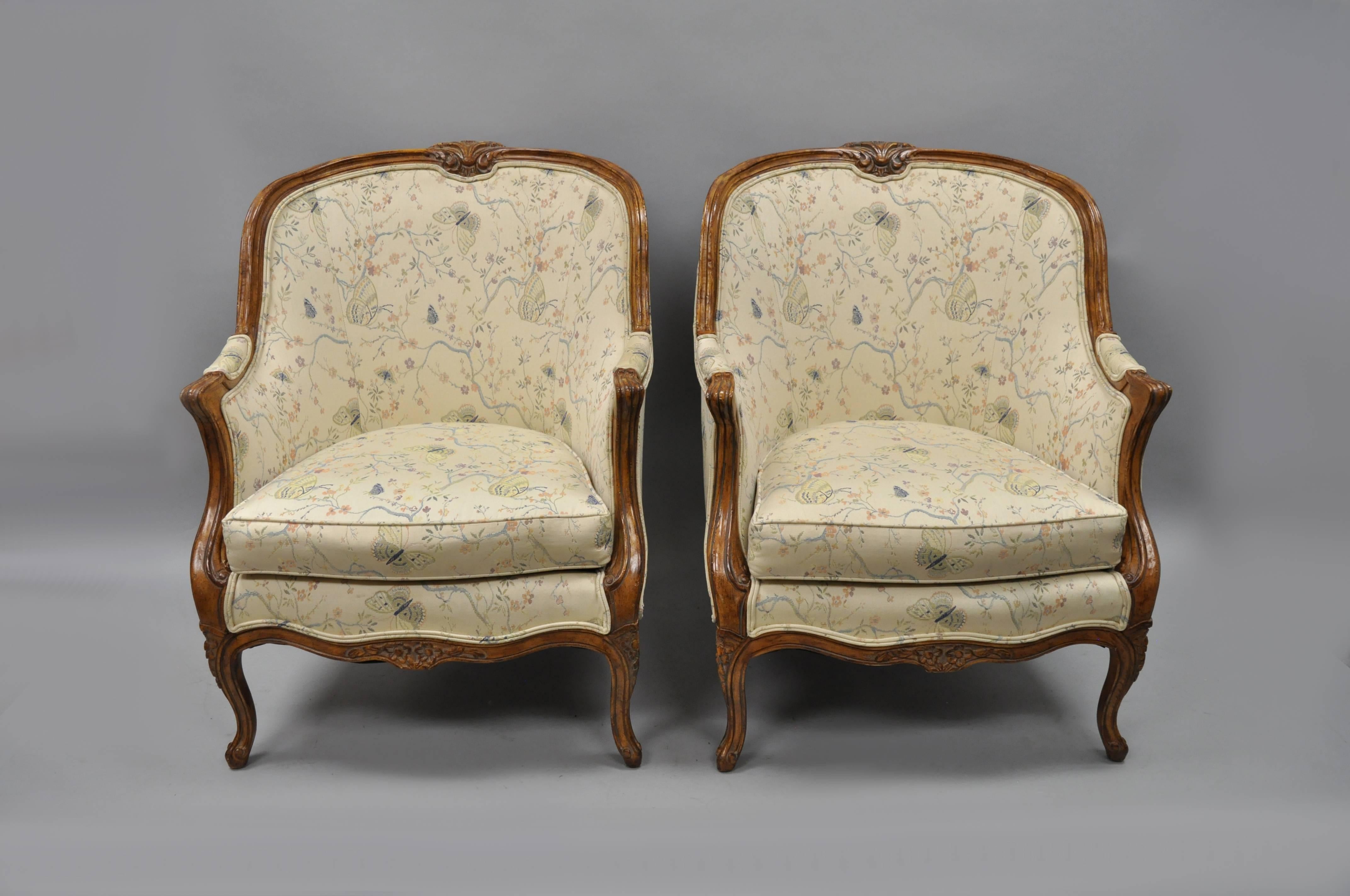 Pair of vintage oversized French Country / Louis XV style bergère armchairs. Chairs feature nice large scale, rounded barrel backs, cabriole legs, nicely carved accents, distressed finish, great style and form. Measure: 40