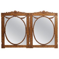 Paire de miroirs de cheminée surdimensionnés en bois doré de style Empire français du 20ème siècle