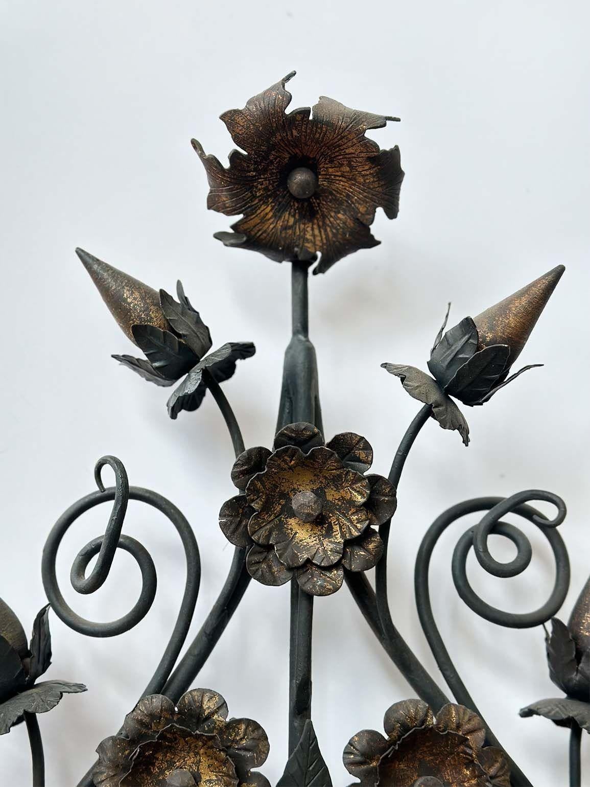 Pair of beautiful oversized girandoles made in Italy in the 1900's. The pairing boasts stunning hand-made wrought ironwork and hand-carved wooden bases.
Each girandole showcases ten candelabra sockets, each rewired to fit US standard, ensuring a
