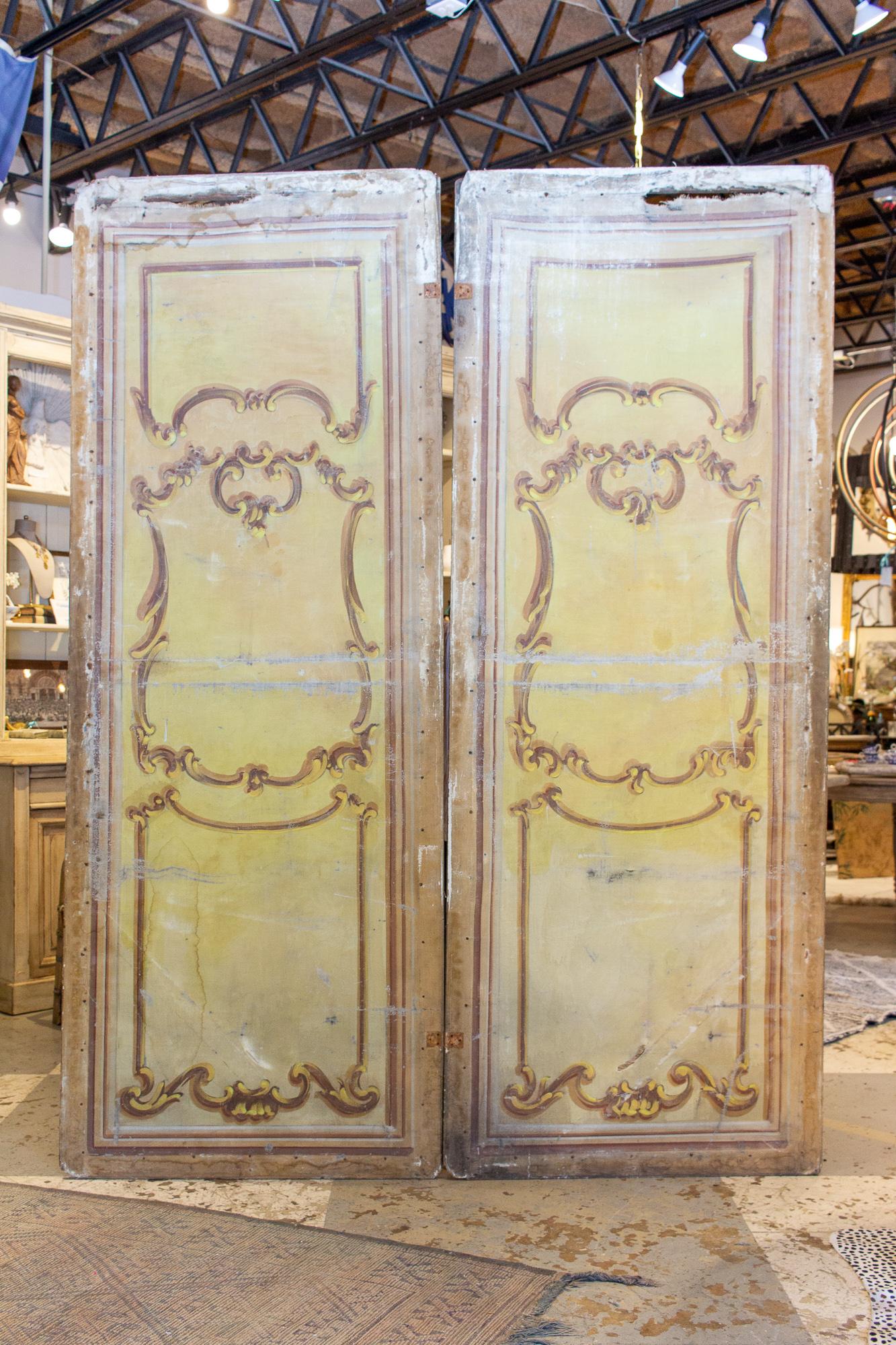 This pair of Italian hand-painted screen panels may have once been used as the backdrop for a stage play, opera or other performance, or they may also simply be oversized panels custom made for a large room divider. Either way, we love how the size